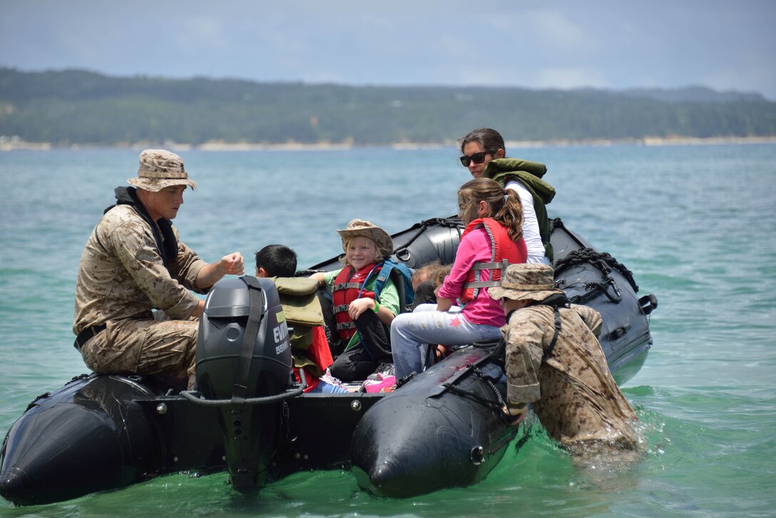 Marines with 3rd Reconnaissance Battalion take children for a ride on a combat rubber raiding craft June 14 at Oura Wan Beach on Camp Schwab during the 2nd annual “Do What Daddy Does” day. The CRRCs are used by reconnaissance Marines for low-profile insertions and extractions. 3rd Recon Bn., Combat Assault Battalion and 4th Marine Regiment, all part of 3rd Marine Division, III Marine Expeditionary Force, hosted the event. 