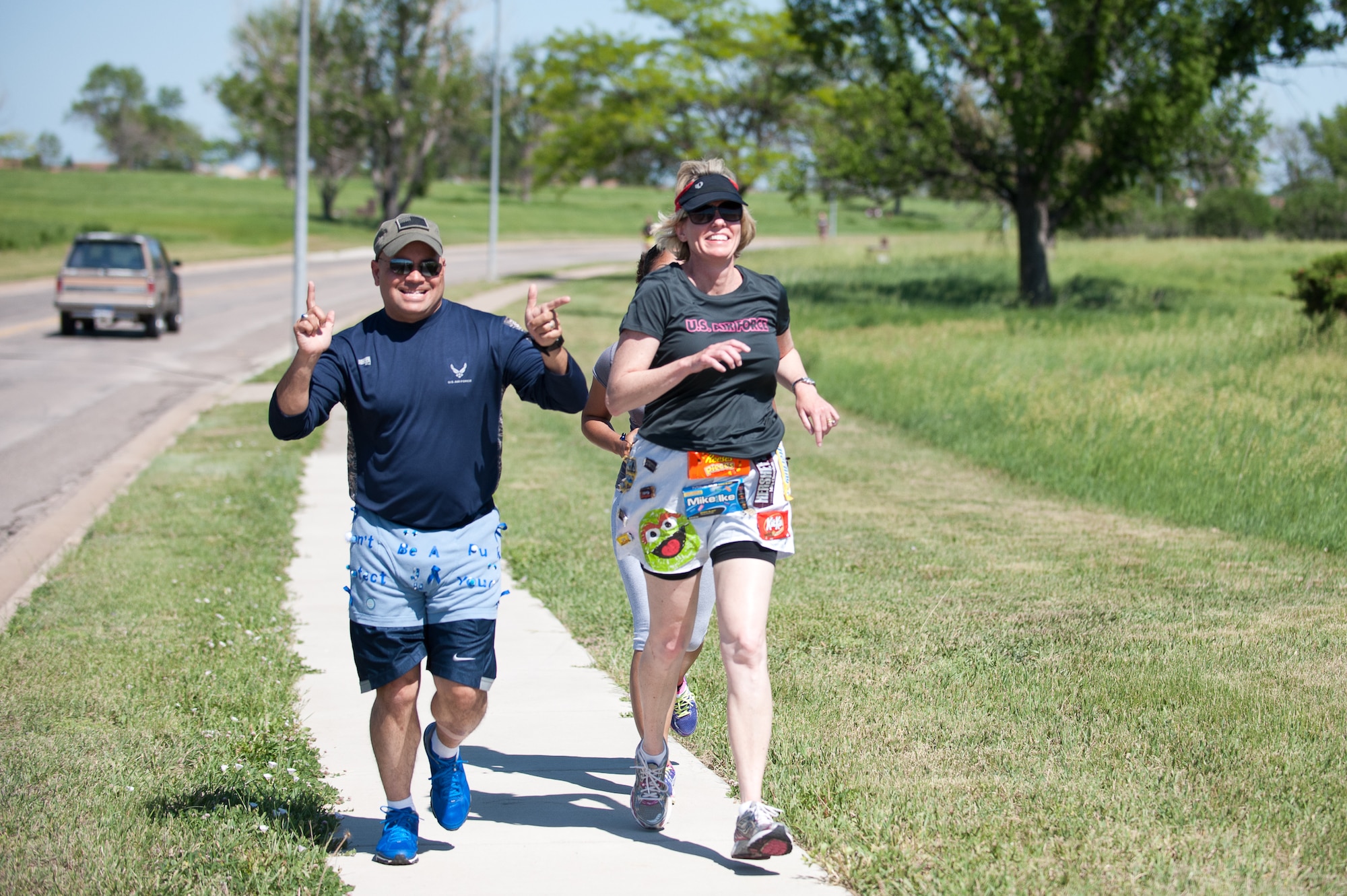 Col. Thomas Goulter Jr. (left), 28th Mission Support Group commander, and Col. Susan Pietrykowski, 28th Medical Group commander, run in their “blinged-out” briefs for the “Bling Your Briefs” 10k at Ellsworth Air Force Base, S.D., June 20, 2013. The 28th Medical Operations Squadron Health and Wellness Center hosted the event to prompt men to take a proactive approach toward their health. (U.S. Air Force photo by Airman 1st Class Alystria Maurer/Released)