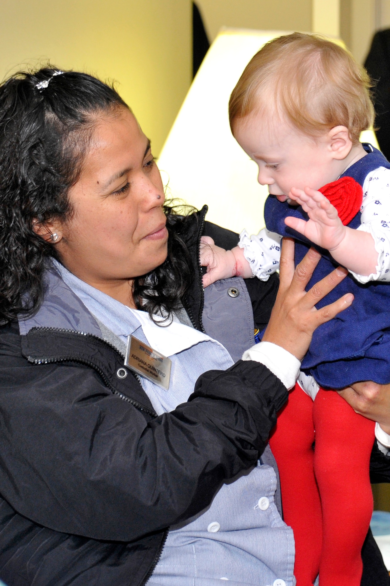 VANDENBERG AIR FORCE BASE, Calif. -- Adriana Quintero, 30th Force Support Squadron lodging housekeeper, reunites with Peyton Paschall, the baby she helped rescue from choking, during an award presentation ceremony here Tuesday, Jun. 18. Quintero was honored for her heroic response and for going above and beyond the call of duty in her support of Vandenberg lodging guests. (U.S. Air Force photo/Michael Peterson)
