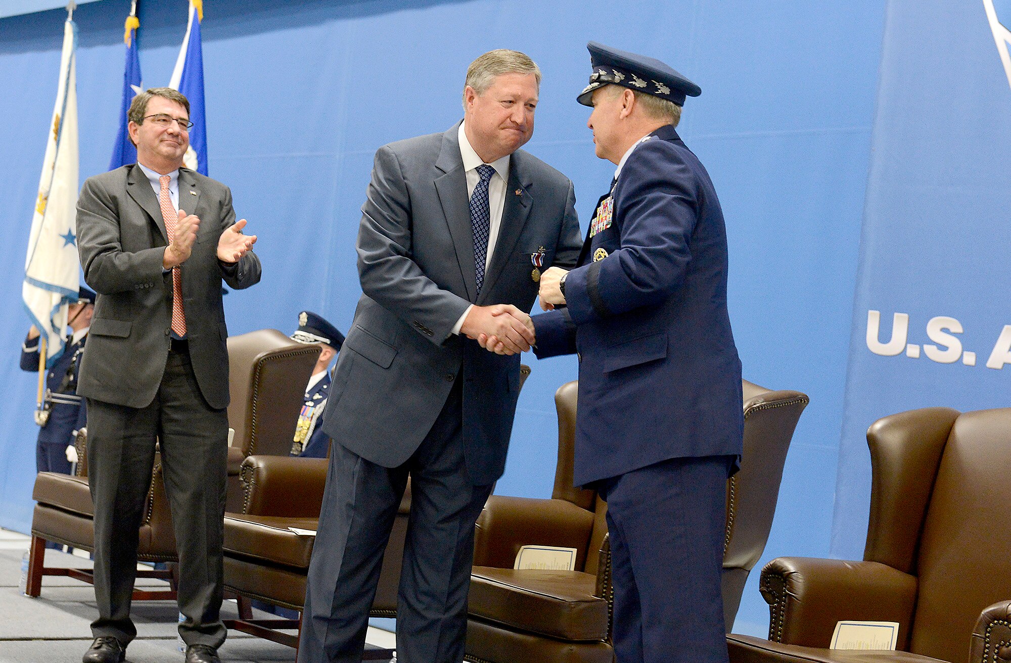 Air Force Chief of Staff Gen. Mark A. Welsh III congratulates Secretary of the Air Force Michael Donley during Donley's farewell ceremony, June 21, 2013, at Joint Base Andrews, Md., while Deputy Secretary of Defense Ash Carter looks on. (U.S. Air Force photo/Scott M. Ash)