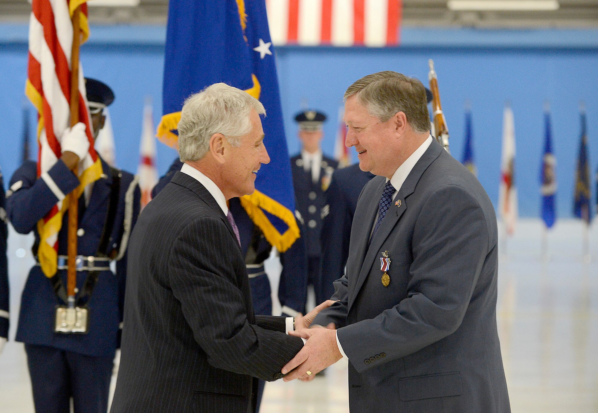Secretary of Defense Chuck Hagel congratulates Secretary of the Air Force Michael Donley at a farewell ceremony in Donley's honor, June 21, 2013, at Joint Base Andrews, Md. Donley was confirmed as the 22nd secretary of the Air Force, Oct. 2, 2008. He had been serving as the acting secretary since June of that year, as well as for seven months in 1993, making him the longest-serving secretary of the Air Force in the service’s history. (U.S. Air
Force photo/Scott M. Ash)
