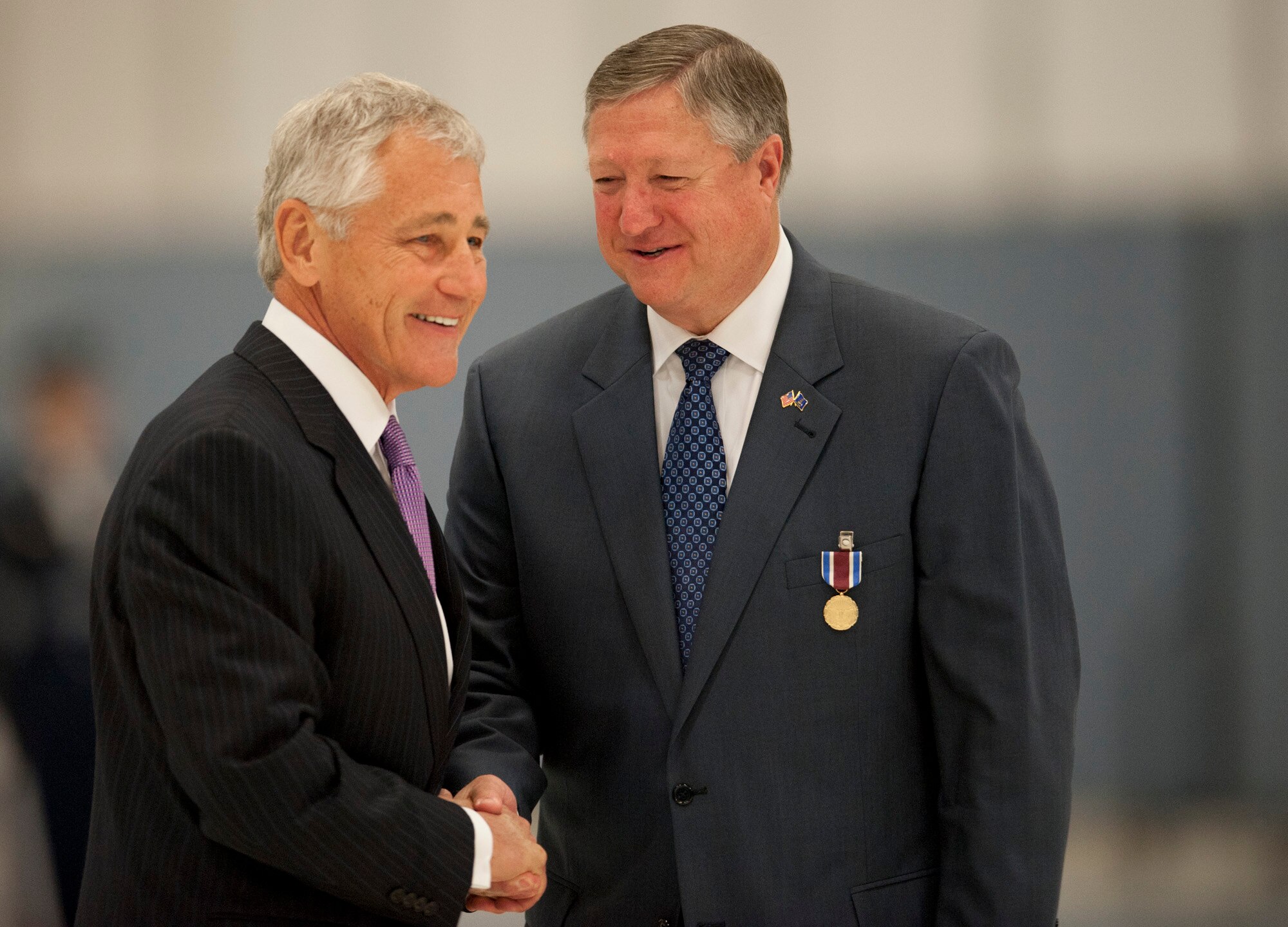 Secretary of the Air Force Michael Donley shakes hands with Secretary of Defense Chuck Hagel during a farewell ceremony, June 21, 2013, at Joint Base Andrews, Md. Donley was confirmed as the 22nd secretary of the Air Force, Oct. 2, 2008.  Donley had been serving as the acting secretary since June of that year, as well as for seven months in 1993, making him the longest-serving secretary of the Air Force in the service’s history. (U.S. Air Force photo/Senior Airman Carlin Leslie)
