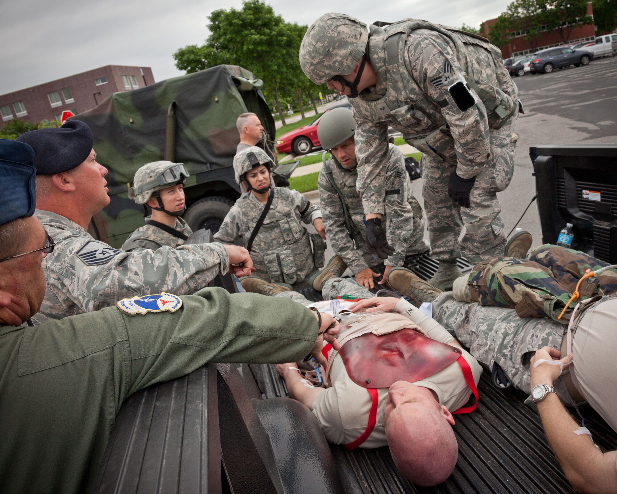 In a mock deployment scenario, Security Forces Airmen describe the actions they would take to transport two injured Marines that are delivered to the entry control point.  Members of the 934th Airlift Wing participated in an Operational Readiness Exercise during the week of June 17-21 at the Minneapolis-St. Paul Air Reserve Station, Minn.  (U.S. Air Force photo/Shannon McKay)