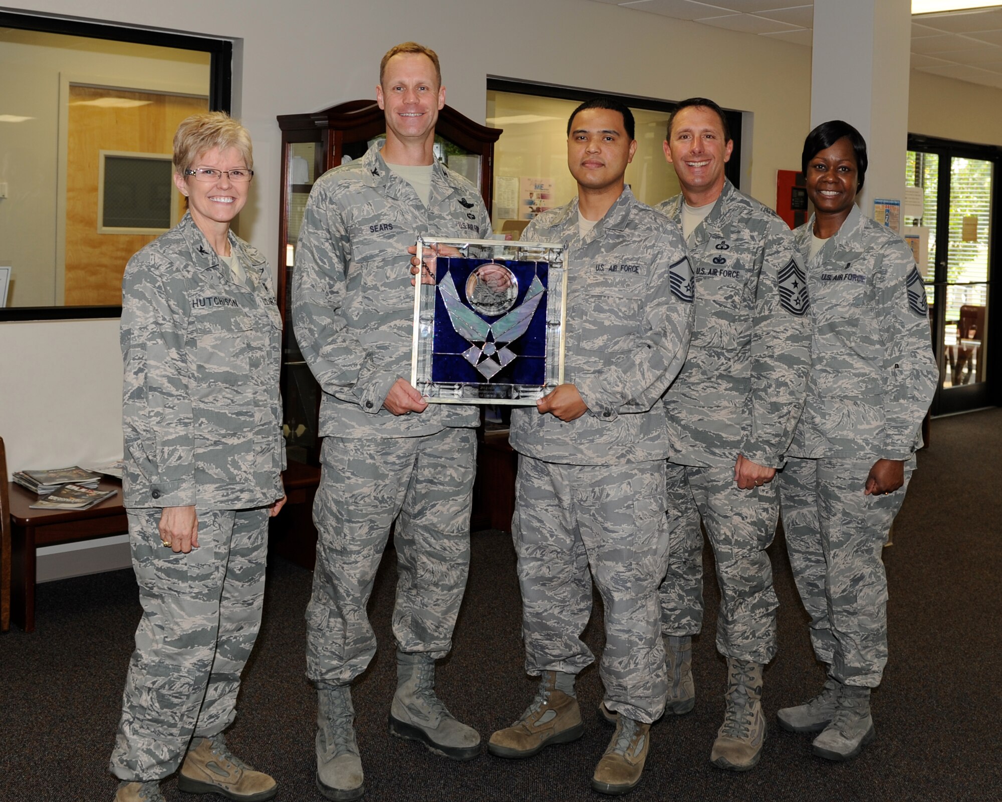 Col. Jim Sears, 14th Flying Training Wing Commander, along with Col. Billye Hutchinson, 14th Medical Group Commander, Chief Master Sgt. Vance Kondon, 14th Flying Training Wing Command Chief, and Chief Master Sgt. Maxine White, 14th Medical Group Superintendent, present Master Sgt. Christopher Calo, 14th Medical Support Squadron, with the Air Education and Training Command Airman of the Year award for 2012.  Calo first achieved Airman of the Year at the Columbus Air Force Base level before being forwarded to and winning the AETC Airman of the Year award.  (U.S. Air Force Photo)