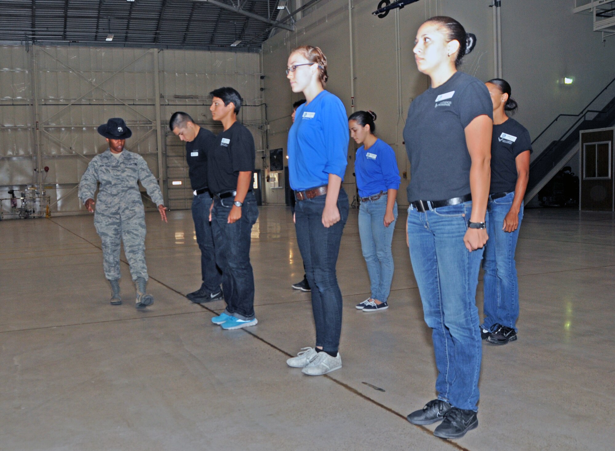 Tech. Sgt. Terri Taylor-Trapp, 433rd Training Readiness Squadron Reserve Training instructor, visiting from Lackland Air Force Base, lines new recruits up as she gives them advice on how to excel during basic military training. (U.S. Air Force photo/Tech. Sgt. Louis Vega Jr.) 