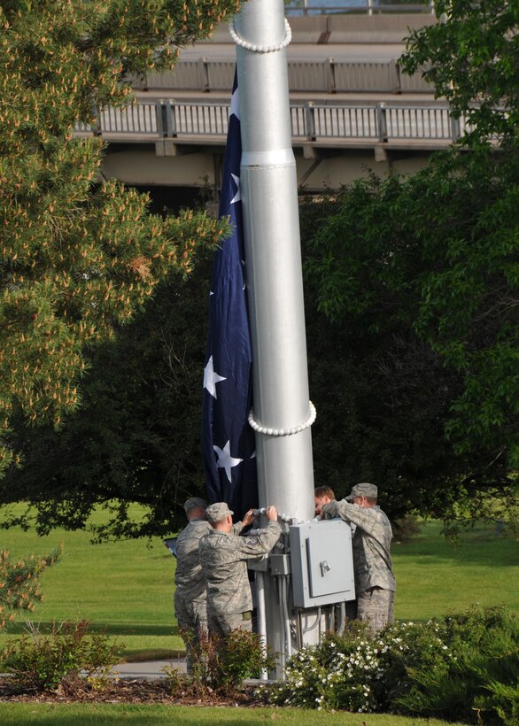 120th Fighter Wing members raise the flag at Broadwaer Overlook Park during the Flag Day ceremony in Great Falls, Mont., on June 14. Eight Guardsmen volunteer to maintain the large flag throughout the year.  (Air National Guard photo/Senior Master Sgt. Eric Peterson)  