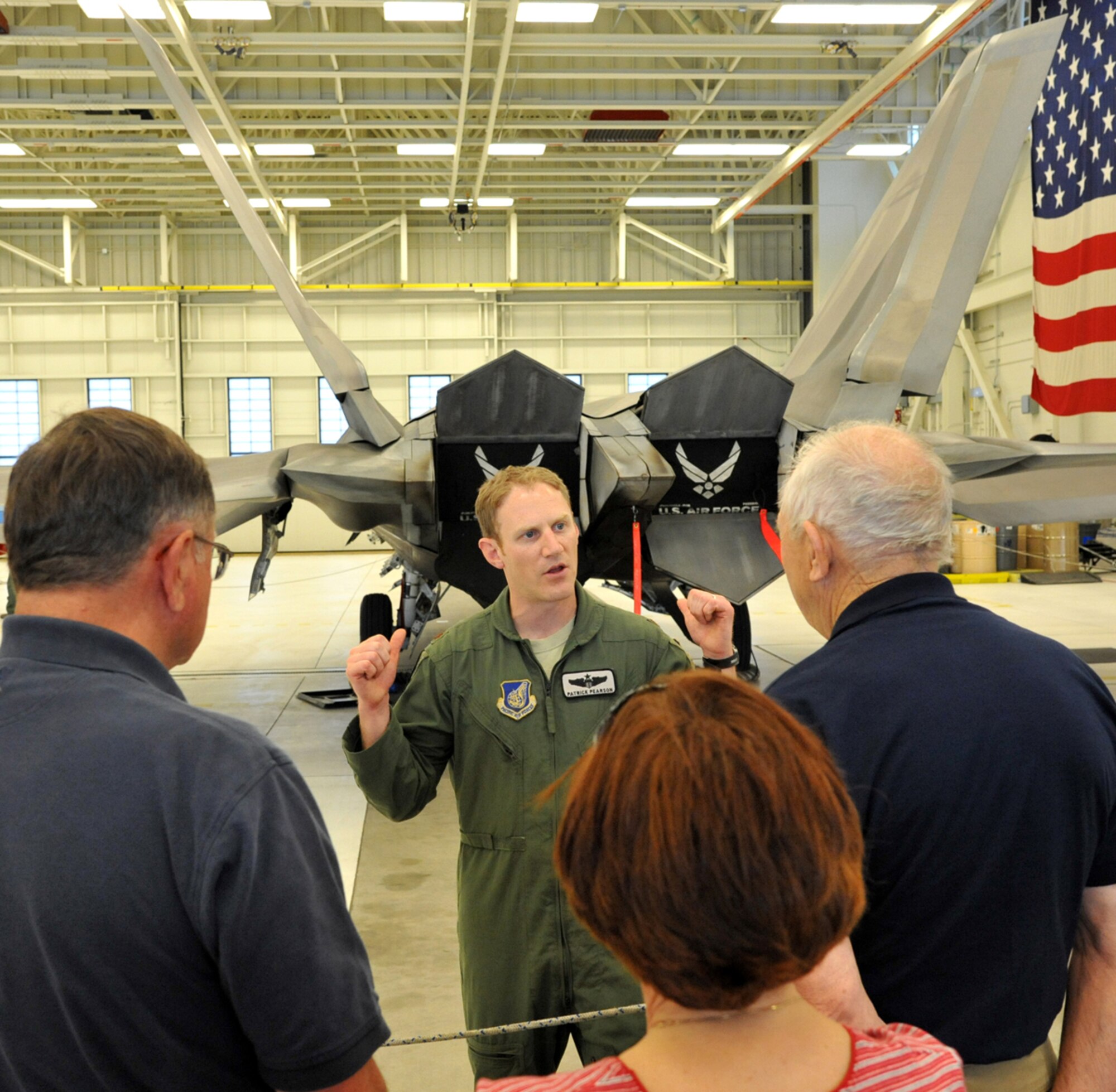 JOINT BASE ELMENDORF-RICHARDSON, Alaska - Air Force Maj. Patrick Pearson, 3rd Wing executive officer and F-22 pilot, leads a tour of Joint Base Elmendorf-Richardson for members of the 43rd Tactical Fighter Squadron, which was based at what was then Elmendorf Air Force Base from 1970 until 1994, June 14. The former Airmen reunited on JBER, along with some of their family members, to commemorate the 43rd anniversary of the squadron being activated here. (U.S. Air Force photo/Senior Airman Blake Mize)