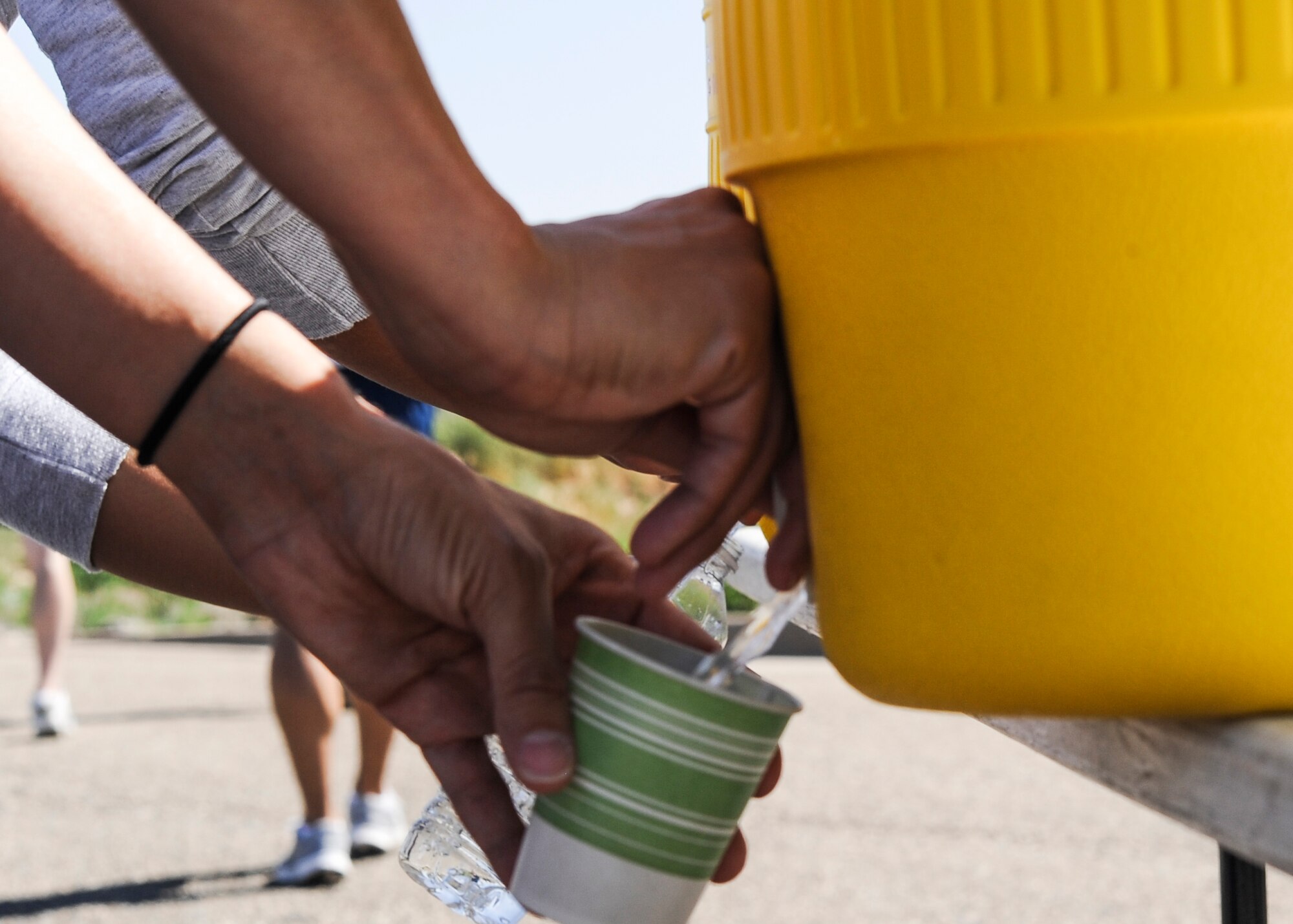 A Team Buckley member takes a water break during a walk and talk June 20, 2013, on Buckley Air Force Base, Colo. Members of the 460th Space Wing took part in a Sexual Assault Prevention and Response stand-down day.  The day consisted of a commander’s call, briefings, a walk and talk, a burger burn and small-group discussions. (U.S. Air Force photo by Staff Sgt. Christopher Gross/Released)