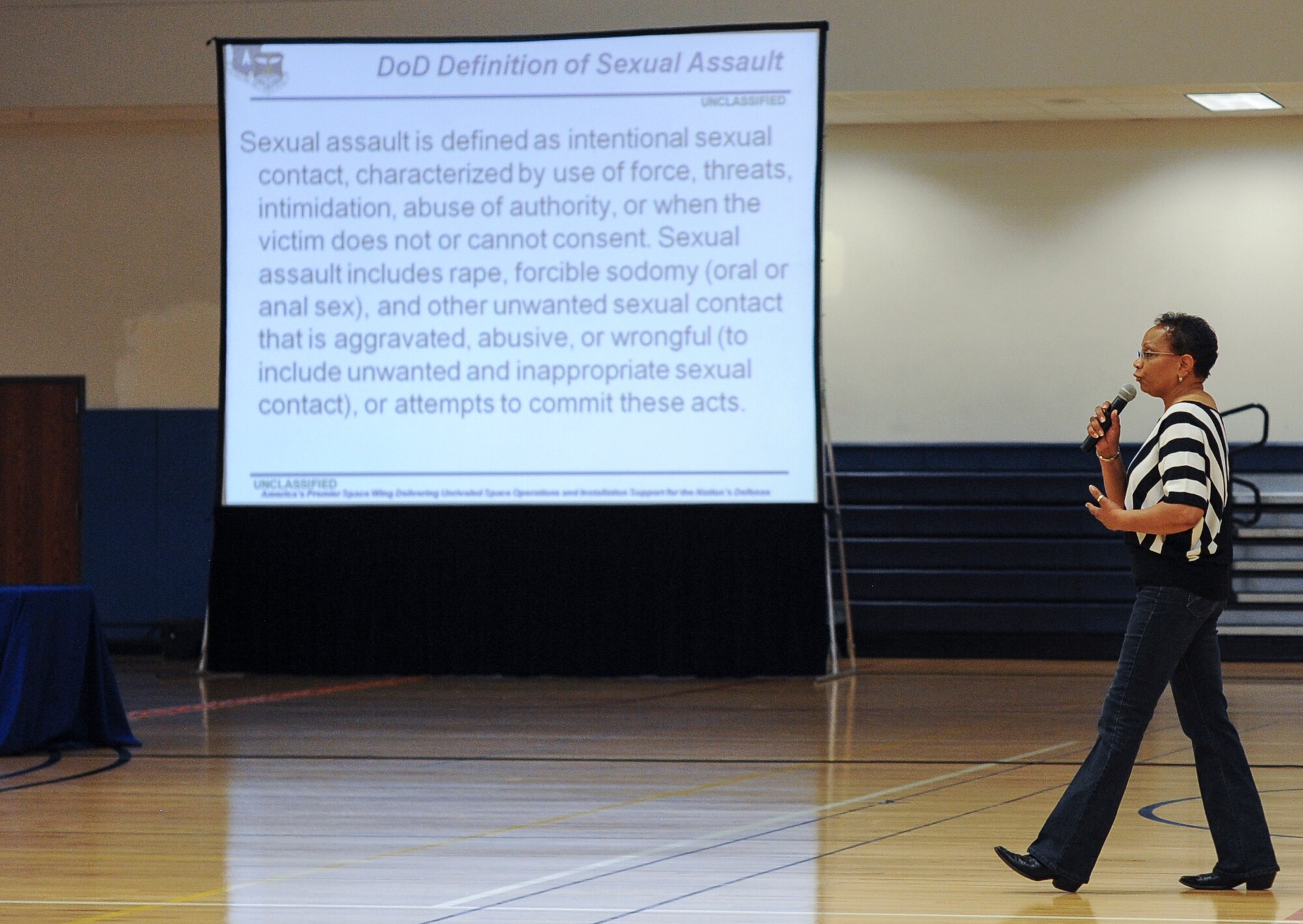 Peggy Moore-McCoy, 460th Space Wing sexual assault response coordinator, briefs members of Team Buckley about the Department of Defense definition of sexual assault June 20, 2013, at the fitness center on Buckley Air Force Base, Colo. Moore-McCoy also informed military members the different type of sexual assault reporting and the privileges that go with them. (U.S. Air Force photo by Staff Sgt. Paul Labbe/Released)