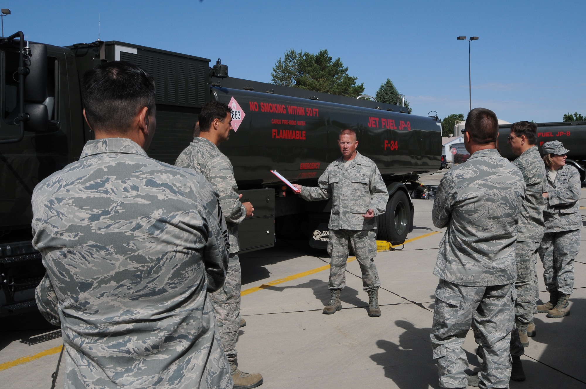 Tech. Sgt. Brett Johnson, 124th Fighter Wing Logistics Readiness Squadron Fuels, explained the safety precautions taken while fueling an A-10 Thunderbolt II to a tour group at the LRS open house at Gowen Field July 13. (Air National Guard Photo by Tech. Sgt. Sarah Pokorney)