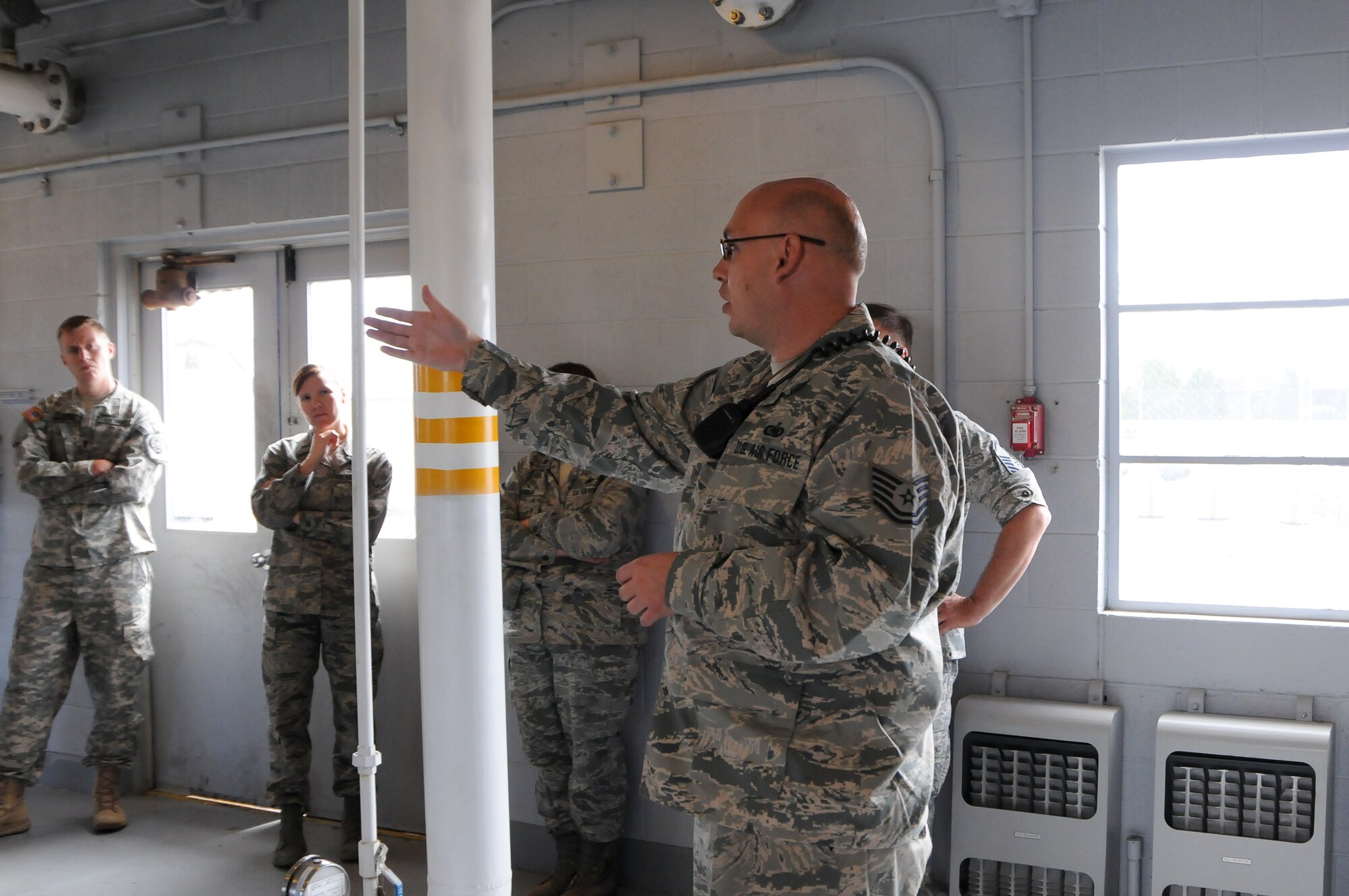 Tech. Sgt. Zachary Shields, Fuels Technician with 124th Fighter Wing Logistics Readiness Squadron Fuels, showed visitors the JP-8 fuel holding tanks, filtration process, and pipeline that provides go-go juice for the A-10 Thunderbolt II at the LRS open house at Gowen Field July 13. (Air National Guard Photo by Tech. Sgt. Sarah Pokorney)