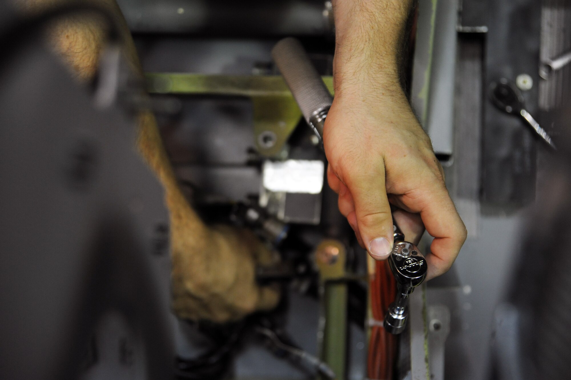Senior Airman John T. Eckardt, 372nd Training Squadron, Det. 6, B-2 Spirit instruments and flight controls instructor, works on the parts that control the B-2 Spirit’s pitch at Whiteman Air Force Base, Mo., June 12, 2013. Eckardt, who has an avionics background, is new to the unit and is currently going through the training needed to become a full-fledged instructor.  (U.S. Air Force photo by Staff Sgt. Brigitte N. Brantley/Released)