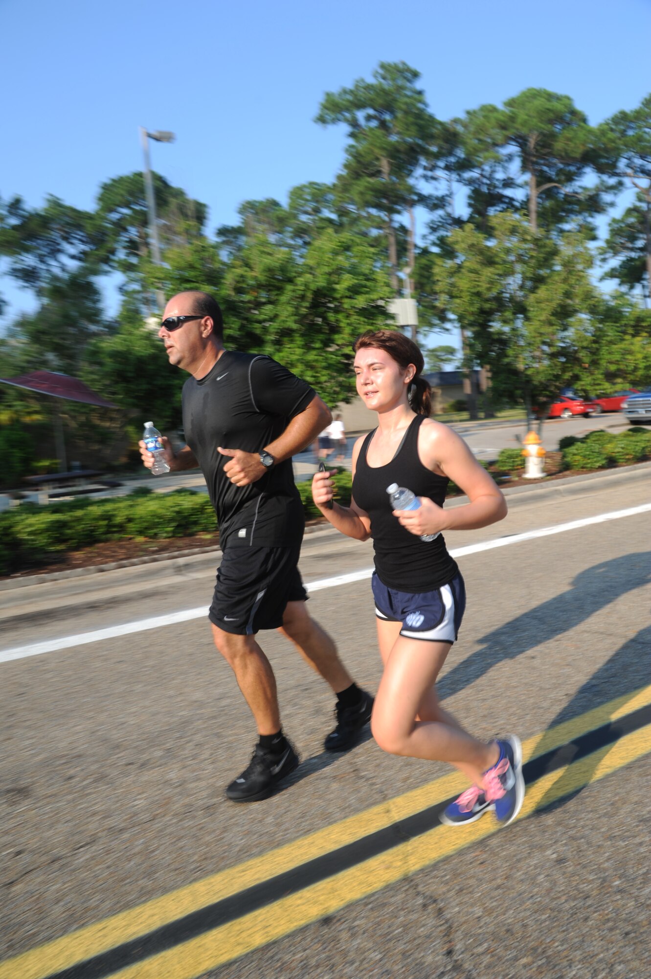 Tech. Sgt. Humberto Camara, 345th Airlift Squadron, and Senior Airman Danni McNeese, 815th Engineering Installation Squadron, participate in a 5K run June 21, 2013, at Keesler Air Force Base, Miss., to show their support for Oklahoma tornado victims. More than 400 people pre-registered for the run and team Keesler raised more than $10,000 total to help aid in relief efforts.  (U.S. Air Force photo by Kemberly Groue)