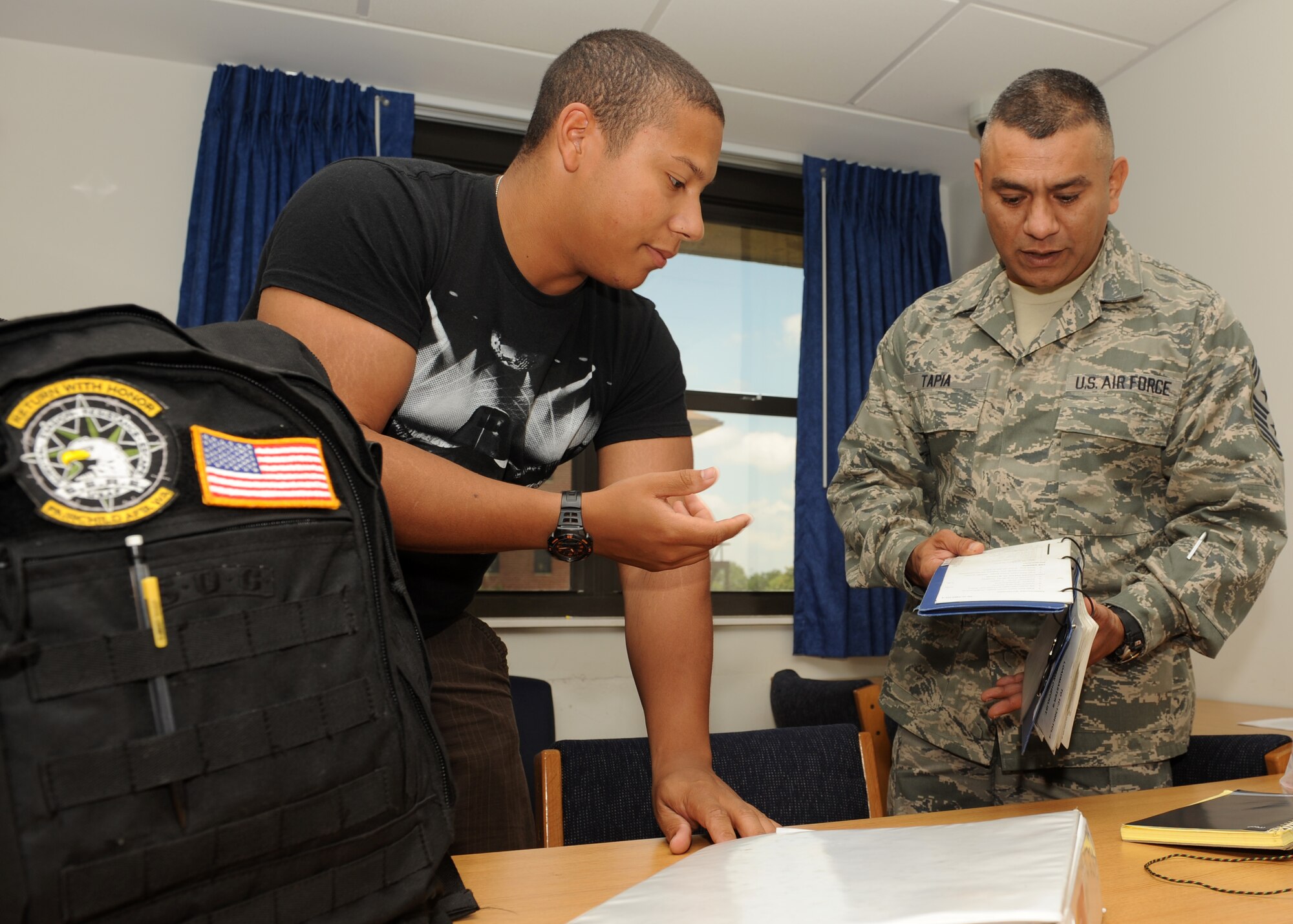 Chief Master Sgt. Geraldo Tapia, Air Education and Training Command command chief, looks through an aircrew publication while interacting with dorm residents June 19, 2013, at Little Rock Air Force Base, Ark. Tapia toured the 714th Training Squadron, non-prior service dorms while visiting the base. (U.S. Air Force photo by Airman 1st Class Scott Poe) 