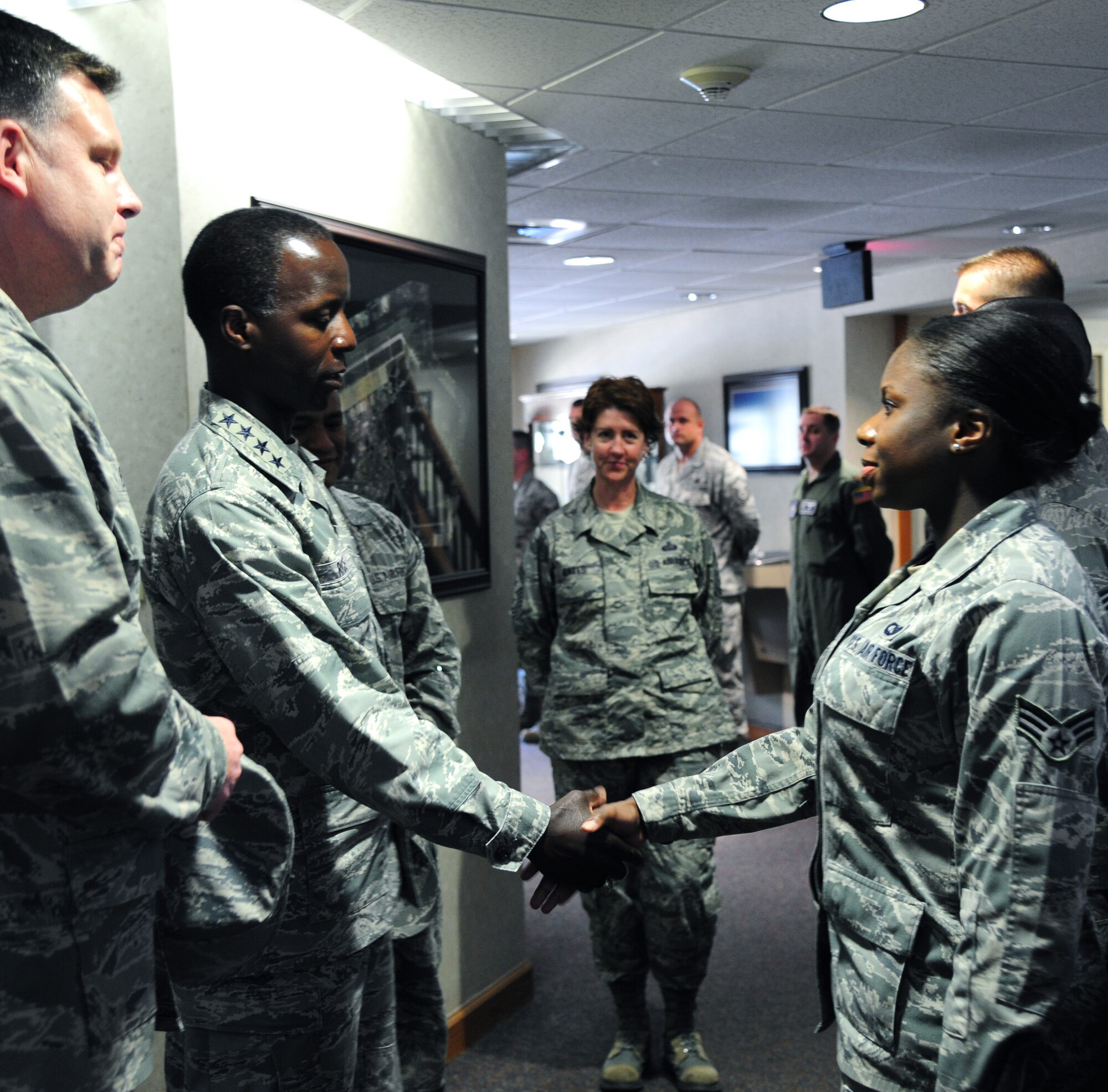 Gen. Edward A. Rice Jr., Air Education and Training Command commander, recognizes Airmen for their contributions to the 314th Airlift Wing mission, June 19, 2013, at Little Rock Air Force Base, Ark. Rice congratulates Senior Airman Joya Lewis, a member of the 62nd Airlift Squadron, one of the AETC Airmen recognized for outstanding performance. (U.S. Air Force photo by Airman 1st Class Kaylee Clark)