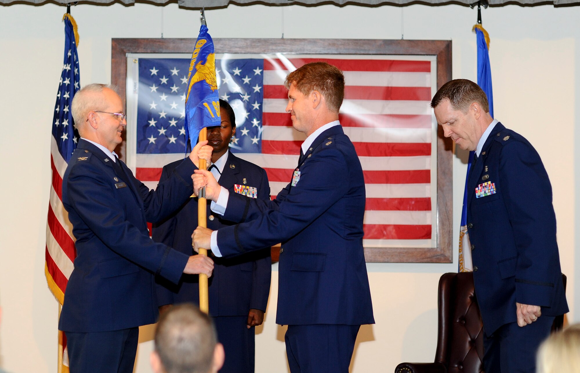 Col. Donald Molnar, left, commander of the 1st Special Operations Medical Group passes the 1st Special Operations Medical Operations Squadron guidon to Lt. Col. David Byer during the 1st SOMDOS change of command at the 8th Special Operations Squadron auditorium on Hurlburt Field, Fla., June 20, 2013. Byer took command after serving as Air Force senior developmental fellow at Argonne National Laboratory just west of Chicago, Ill. (U.S. Air Force photo by Airman 1st Class Jeffrey Parkinson)