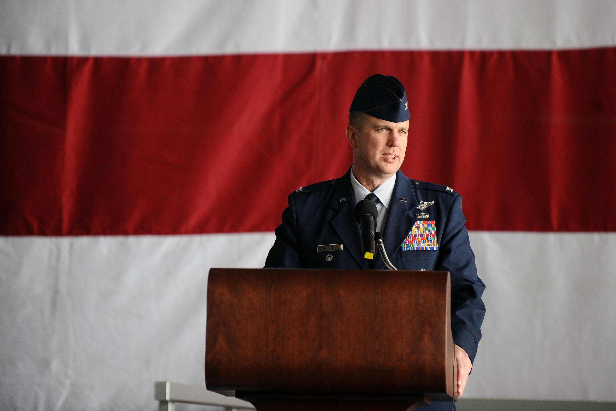 U.S. Air Force Col. Gregory Guillot, 55th Wing commander, addresses the Airmen of Offutt Air Force Base after formally assuming command of the wing at the change of command ceremony held at the Bennie Davis Maintenance Facility on June 19.  (U.S. Air Force photo by Josh Plueger/Released)