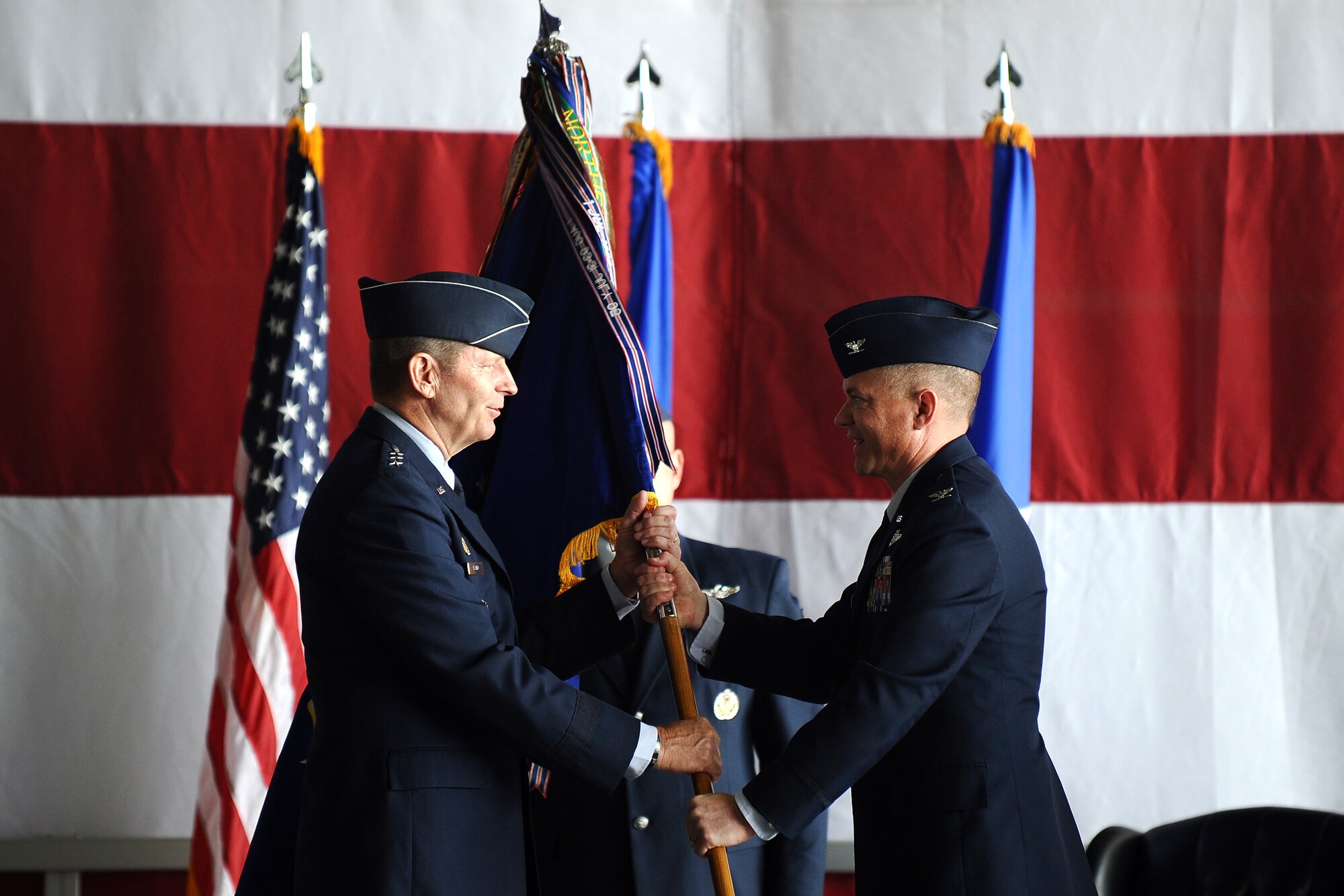 U.S. Air Force Lt. Gen. Robin Rand, 12th Air Force commander, accepts the command guidon as U.S. Air Force Col.  John Rauch relinquishes command after serving one year as the 55th Wing commander on June 19 at Offutt Air Force Base, Neb.  Rauch will continue his career at the Pentagon in Washington D.C. (U.S. Air Force photo by Josh Plueger/Released)