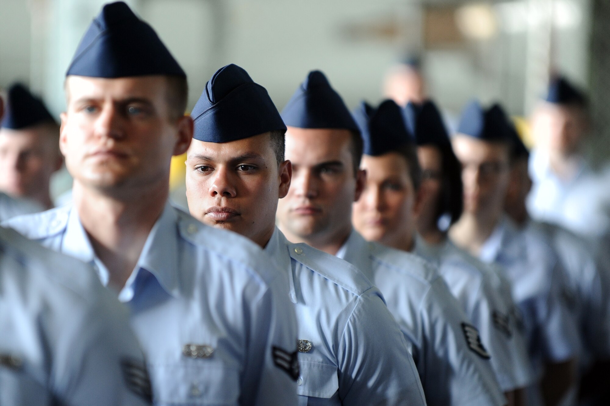 55th Wing Airmen stand in formation to observe the formal change of command ceremony held in the Bennie Davis Maintenance Facility at Offutt Air Force Base, Neb., June 19. U.S. Air Force Col. Gregory Guillot accepted the command guidon from U.S. Air Force Lt. Gen. Robin Rand, 12th Air Force commander, as the new wing commander.  (U.S. Air Force photo by Josh Plueger/Released)