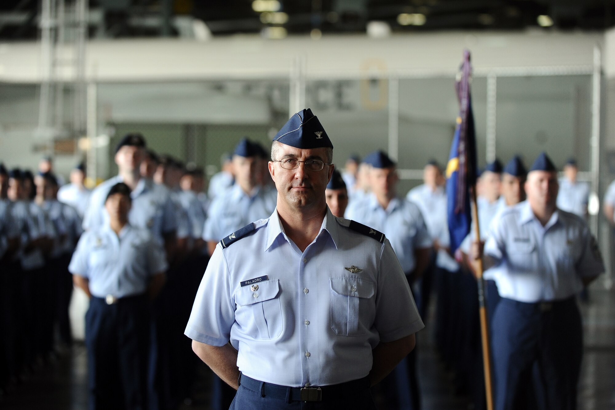 U.S. Air Force Col. Hans F. Palaoro, 55th Wing vice commander, heads a formation comprised of the wing’s five groups as they watch the command guidon pass from U.S. Air Force Col. John Rauch to the incoming 55th Wing commander U.S. Air Force Col. Gregory Guillot at the change of command ceremony in the Bennie Davis Maintenance Facility, Offutt Air Force Base, Neb., June 19. In addition to the Airman in attendance, distinguished visitors from across the state of Nebraska were also in attendance to watch the ceremony.  (U.S. Air Force photo by Josh Plueger/Released)