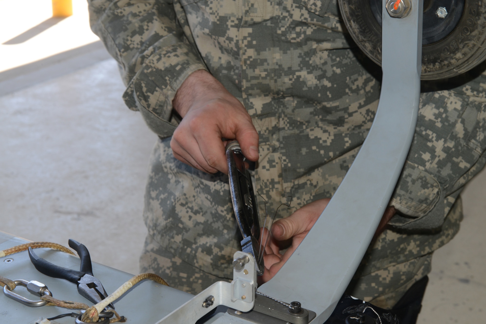 JOINT BASE ELMENDORF-RICHARDSON, Alaska -- Army Spc. David Keasler, 4th Brigade Combat Team (Airborne), 25th Infantry Division unmanned aerial vehicle technical inspector, tightens the main body of a RQ-7 Shadow fuselage at Forward Operating Base Sparta on Joint Base Elmendorf-Richardson June 11. The 4/25 Soldiers conduct this training to prepare for upcoming deployments and future training conducive to the JBER mission. (U.S. Air Force photo/Airman Ty-Rico Lea)