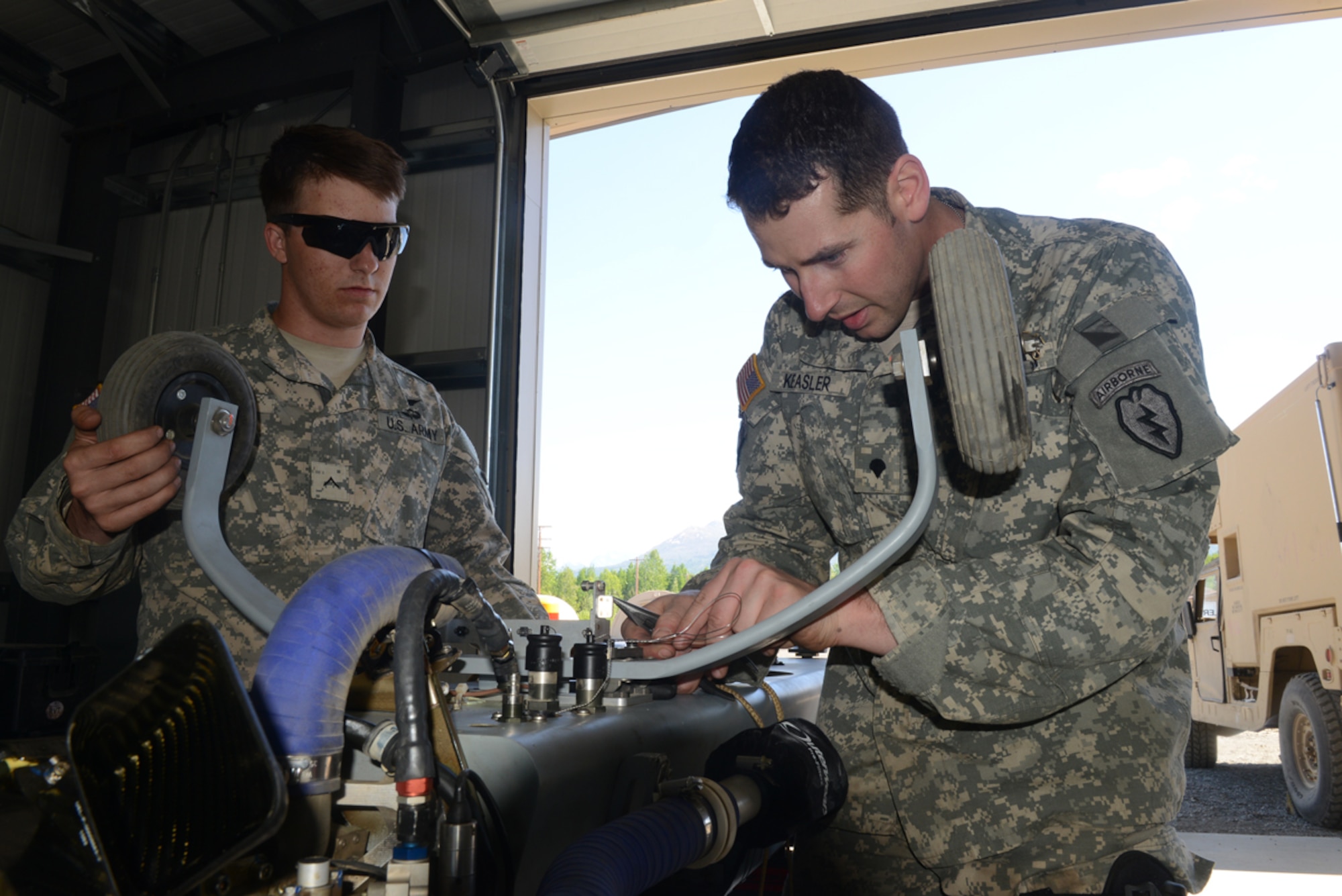 JOINT BASE ELMENDORF-RICHARDSON, Alaska --Army Pvt. Derek Kistler, 4th Brigade Combat Team (Airborne), 25th Infantry Division unmanned aerial vehicle maintainer, and Spc. David Keasler 4/25 UAV technical inspector, assemble a RQ-7 Shadow UAV fuselage during reconnaissance training at Forward Operating Base Sparta on Joint Base Elmendorf-Richardson June 11. The 4/25 Soldiers conduct this training to prepare for upcoming deployments and future training conducive to the JBER mission. (U.S. Air Force photo/Airman Ty-Rico Lea)