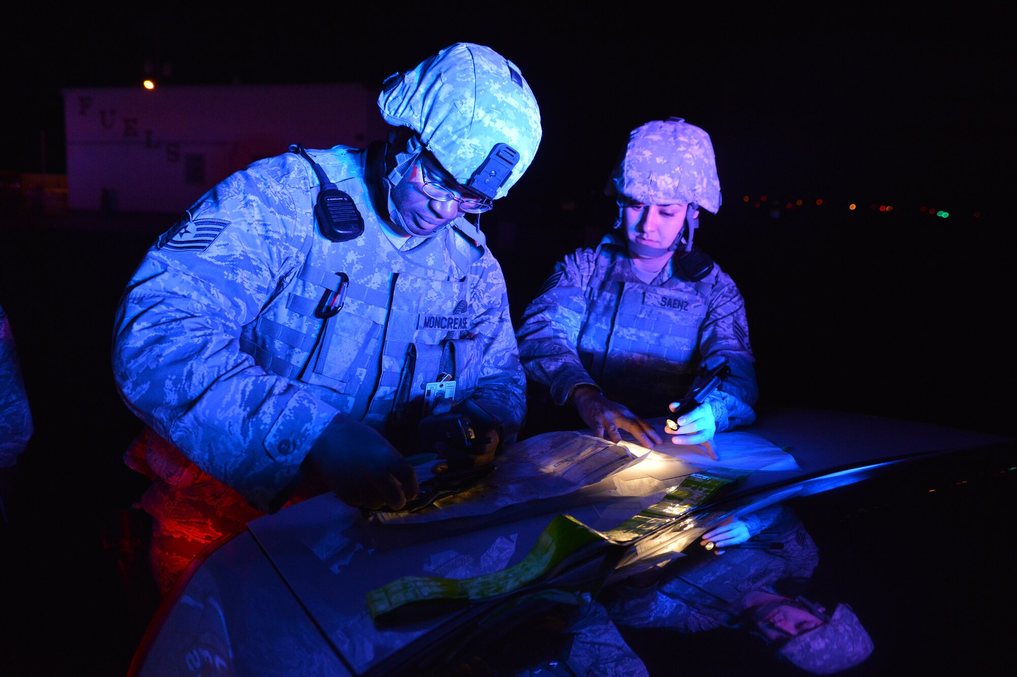 Tech. Sgt. William Moncrease, 56th Security Forces Squadron flight chief, and Staff Sgt. Pricilla Saenz, 56th SFS patrolman, look at a base map found among the evidence gathered during the training exercise. The map, found on the suspect, indicated a plan to attack three targets on base. (U.S. Air Force photo/Airman 1st Class Devante Williams)