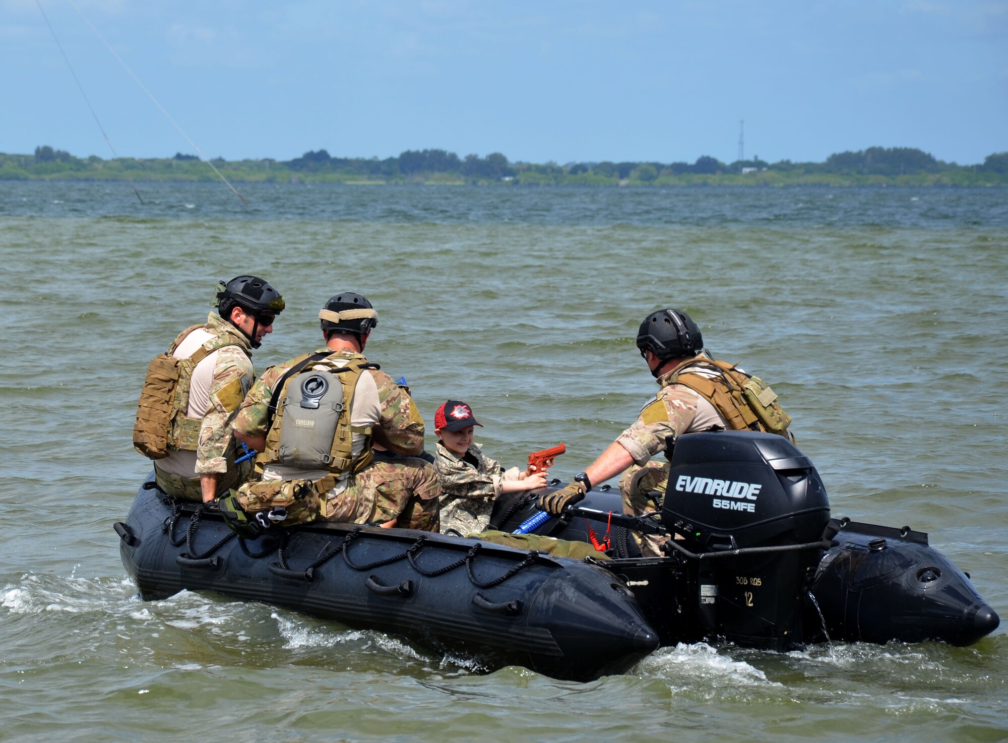 Trevor Scheerer, 5, (shown) and Finnian Gerts, 7, were named team leaders, for a "rescue mission", given kid-sized Airman Battle Uniforms and pseudo military gear. The pararescuemen formed two teams with Trevor and Finnian leading the way, then boarded two awaiting Zodiac boats, making their rescue mission experience authentic. The missions consisted of traveling up the Banana River from the banks of the rescue squadron by boat about a quarter mile north to "rescue" and medically treat the injured pilots; all the while fighting off "enemy attacks". The boys and their families visited the 920th Rescue Wing, Cocoa Beach, Fla., to learn about combat search and rescue and meet the rescue professionals. The boys are both battling cancer and met while in treatment at Arnold Palmer Hospital in Orlando, Fla. They were treated to a day they would never forget - tours of both rescue aircraft, the King and HH-60G Pave Hawk helicopters, and then finished with a "rescue mission" hosted by the pararescuemen here. (U.S. Air Force photo/2nd Lt. Leslie Forshaw)