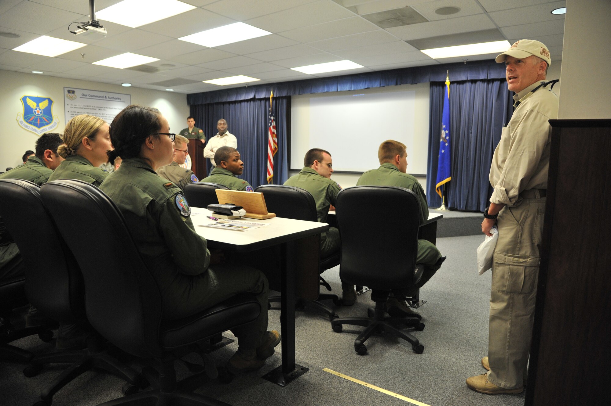 Robi Powers, founder of the American300 Never Quit series tours, speaks to missileers of Malmstrom’s missile squadrons during a pre-departure briefing June 11.  Powers toured Malmstrom with a member of Jamaica’s first bobsled team, Devon Harris, as part of the Keep on Pushing Tour.  (U.S. Air Force photo/John Turner) 