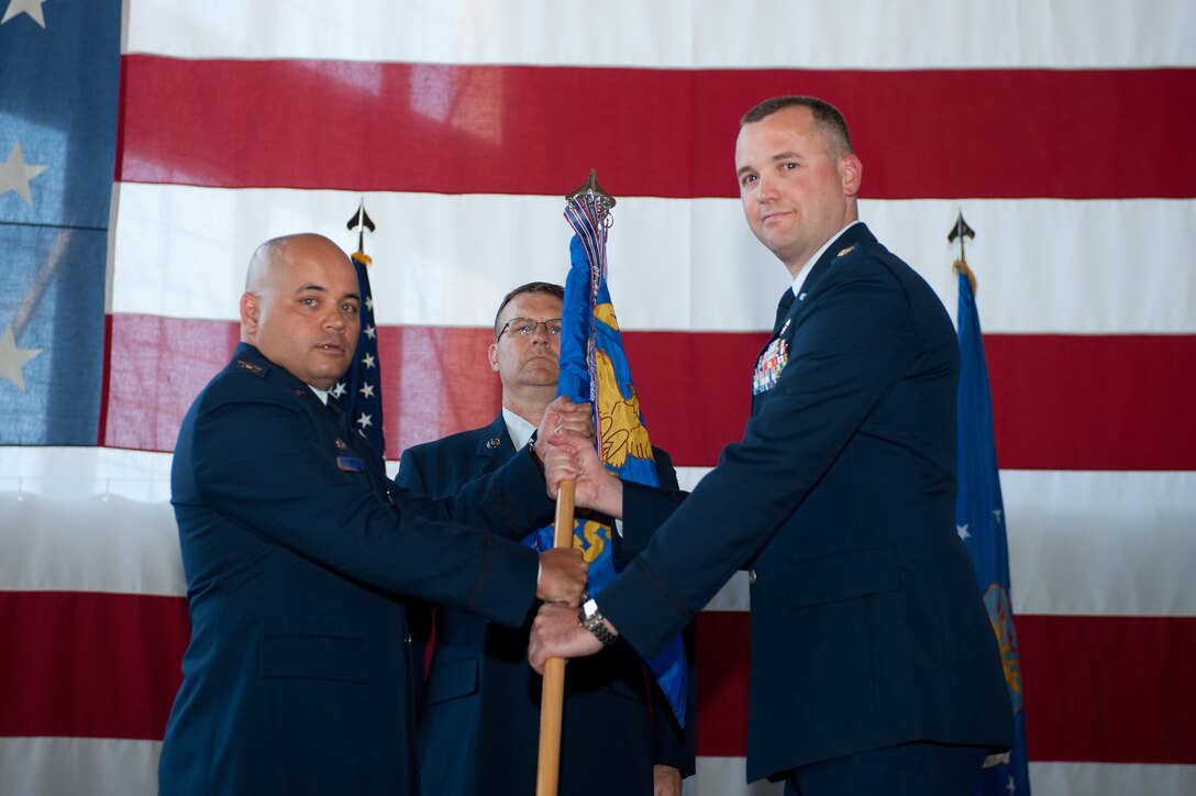Col. Thomas Goulter Jr., 28th Mission Support Group commander, presents the guidon of the 28th Communications Squadron to Maj. Brian Hidy, the new 28th CS commander, during a change of command ceremony at Ellsworth Air Force Base, S.D., June 14, 2013. Hidy, who comes to Ellsworth from Fort Leavenworth, Kan. will command the 28th CS whose mission is to provide combat-ready Airmen in support of warfighter requirements while developing cyberspace professionals focused on world-class customer support to all units assigned to Ellsworth. (U.S. Air Force photo by Airman 1st Class Alystria Maurer/Released)