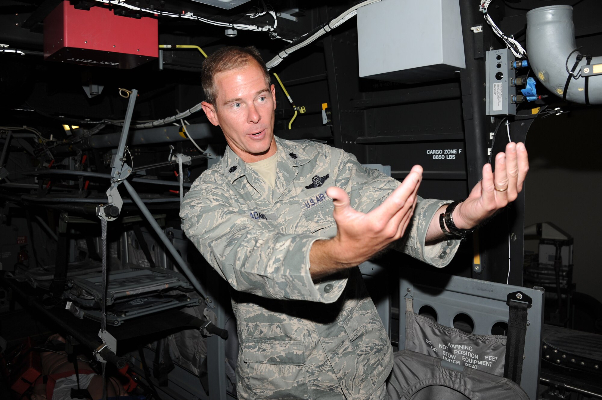 Lt. Col. Ken McAdams, 58th Training Squadron commander, describes to a visitor June 10 how an aircrew training device in the “Monster Garage” helps prepare students for duties aboard 58th Special Operations Wing aircraft at Kirtland AFB. 