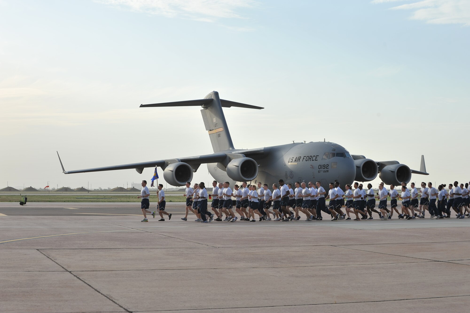 ALTUS AIR FORCE BASE, Okla. – Airmen from the 97th Logistics Readiness Squadron run in formation down the flightline, June 21. The run was a part of a 97th Air Mobility Wing base all-call that gave base leaders a chance to directly engage with Airmen about the Air Force’s current sexual assault and prevention issues. (U.S. Air Force photo by Senior Airman Dillon Davis/Released)