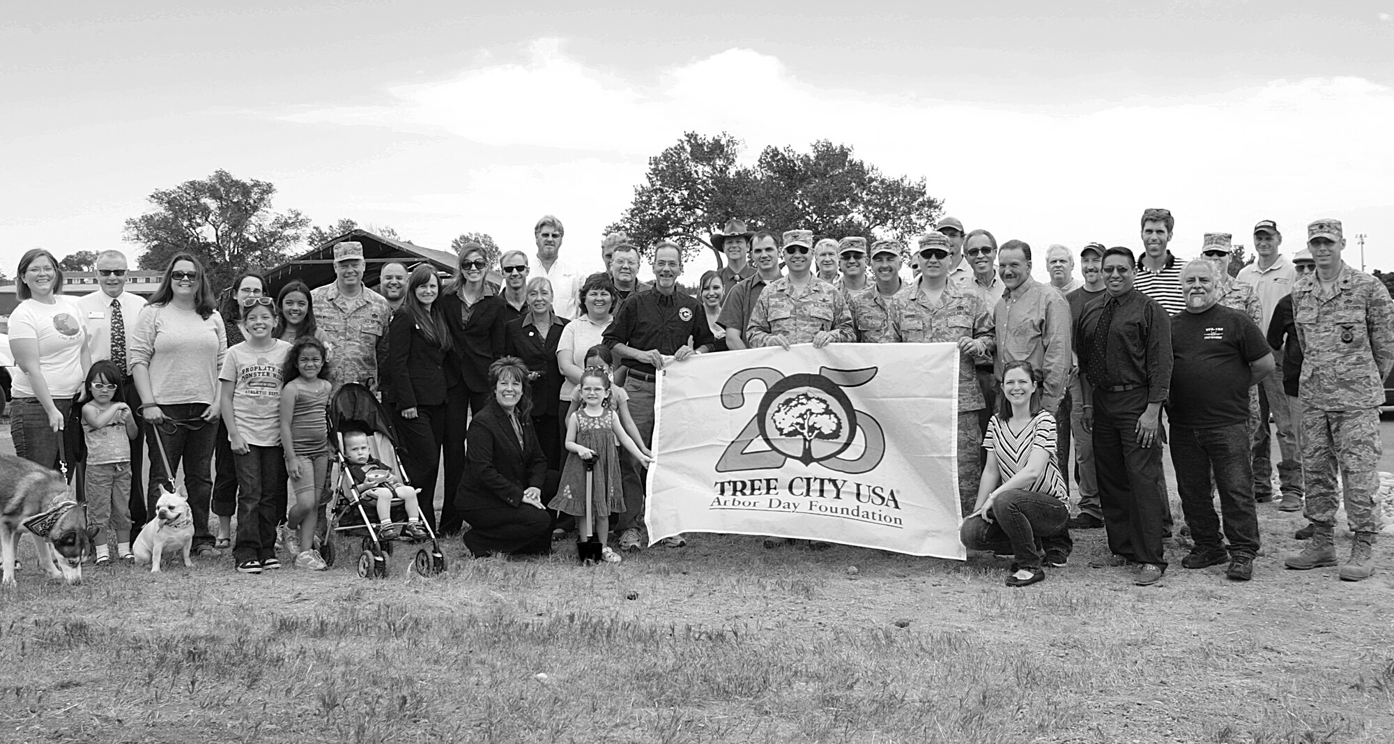 Col. George Farfour, 90th Missile Wing commander, poses for a photograph with community members in celebration of 25 years of F. E. Warren being designated a “Tree City, USA,” June 13, 2013. (U.S. Air Force photo by Matt Bilden)