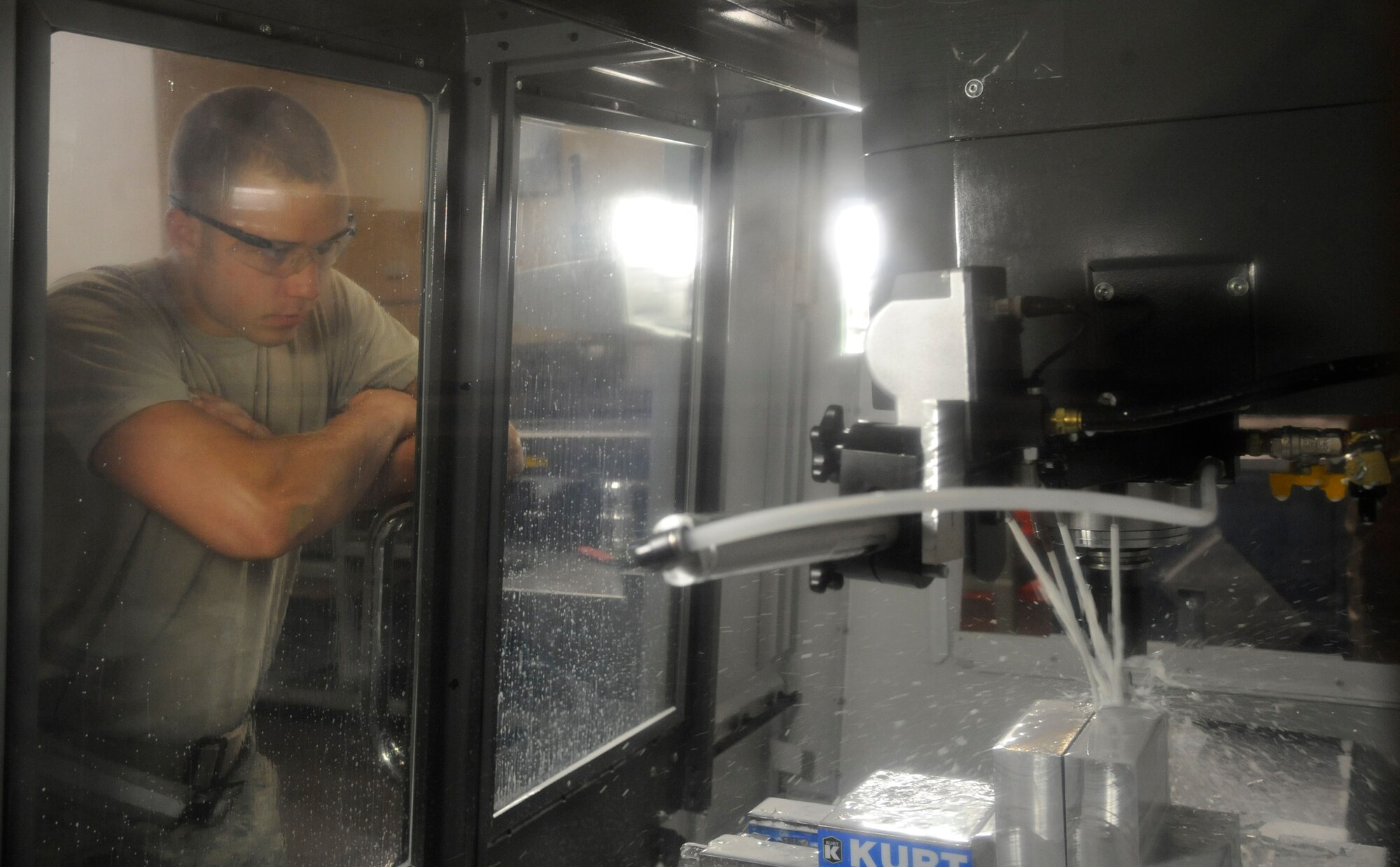 Senior Airman Jared Henden, from the 2nd Maintenance Squadron Fabrication Flight, inspects a finished sniper pod lug on Barksdale Air Force Base, La., June 20, 2013. After each lug is finished, it is inspected to ensure there are no discrepancies or imperfections. (U.S. Air Force photo/Airman 1st Class Andrew Moua)
