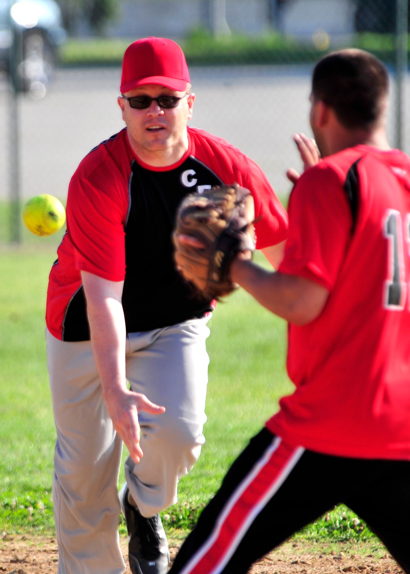 Michael Jobin, 436th Civil Engineer Squadron shortstop, tosses the ball to second baseman Cory McKnight for a force out during an intramural softball game June 20, 2013, at the softball field on Dover Air Force Base, Del. The 436th CES defeated the Air Force Mortuary Affairs Office 16-5. (U.S. Air Force photo/Tech. Sgt. Chuck Walker)