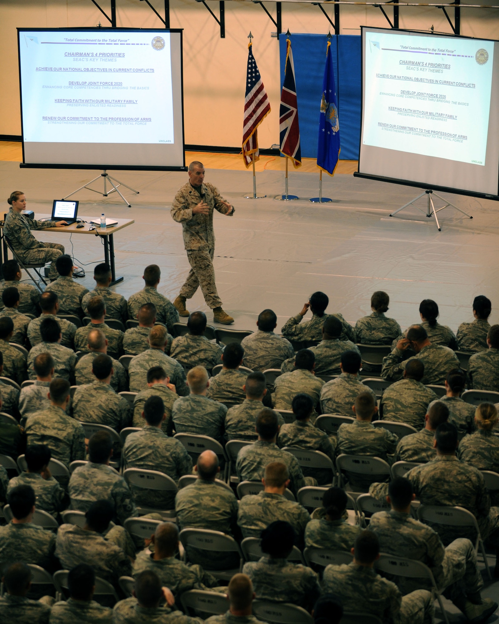 U.S. Marine Corps Sgt. Maj. Bryan Battaglia, senior enlisted advisor to the Chairman of the Joint Chiefs of Staff, addresses Airmen during a town hall meeting June 20, 2013, in the Hardstand Fitness Center on RAF Mildenhall, England. During the town hall meeting, Battaglia explained the four priorities of the Chairman of the JCS. (U.S. Air Force photo by Airman 1st Class Preston Webb/Released)
