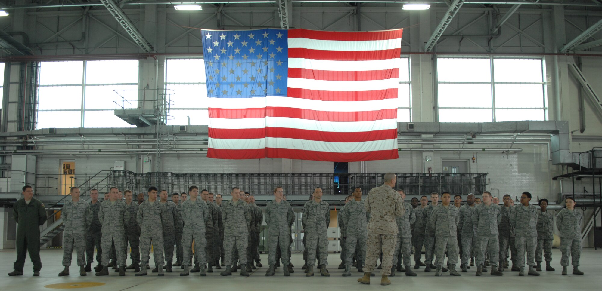 U.S. Marine Corps Sgt. Maj. Bryan Battaglia, senior enlisted advisor to the Chairman of the Joint Chiefs of Staff, speaks with a group of Team Mildenhall Airmen June 20, 2013, during a base visit on RAF Mildenhall, England. Battaglia toured the base, visited static displays and spoke at a base town hall meeting. (U.S. Air Force photo by Airman 1st Class Dillon Johnston/Released)