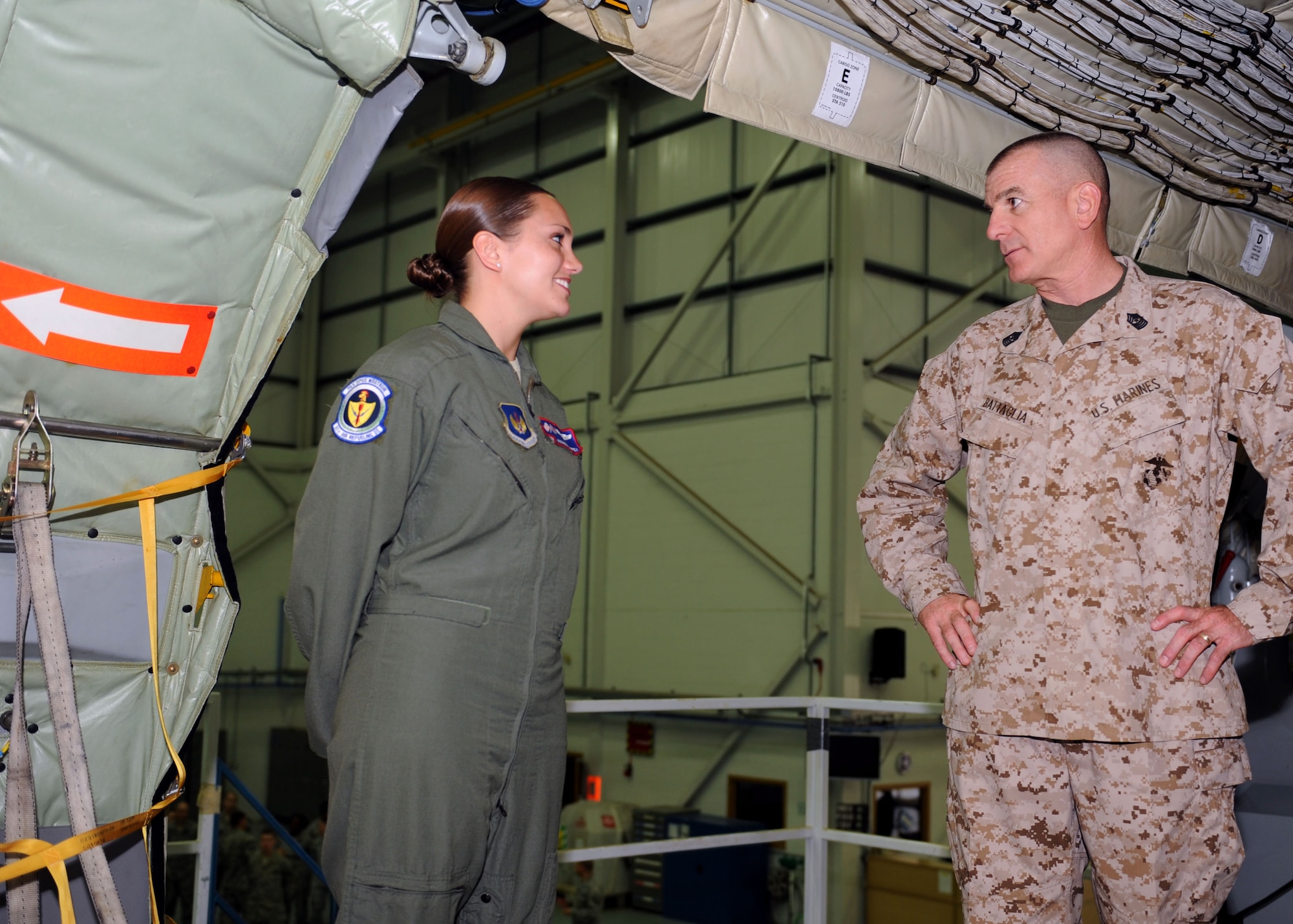 On the left, Senior Airman Amanda Ampey, 351st Air Refueling Squadron boom operator, meets U.S. Marine Corps Sgt. Maj. Bryan Battaglia, senior enlisted advisor to the Chairman of the Joint Chiefs of Staff, before showing him the interior of a KC-135 Stratotanker June 20, 2013, at Hangar 814 during a tour of RAF Mildenhall, England. While on RAF Mildenhall, Battaglia also viewed 352nd Special Operations Group assets, and he addressed Airmen during a base town hall meeting. (U.S. Air Force photo by Airman 1st Class Preston Webb/Released)