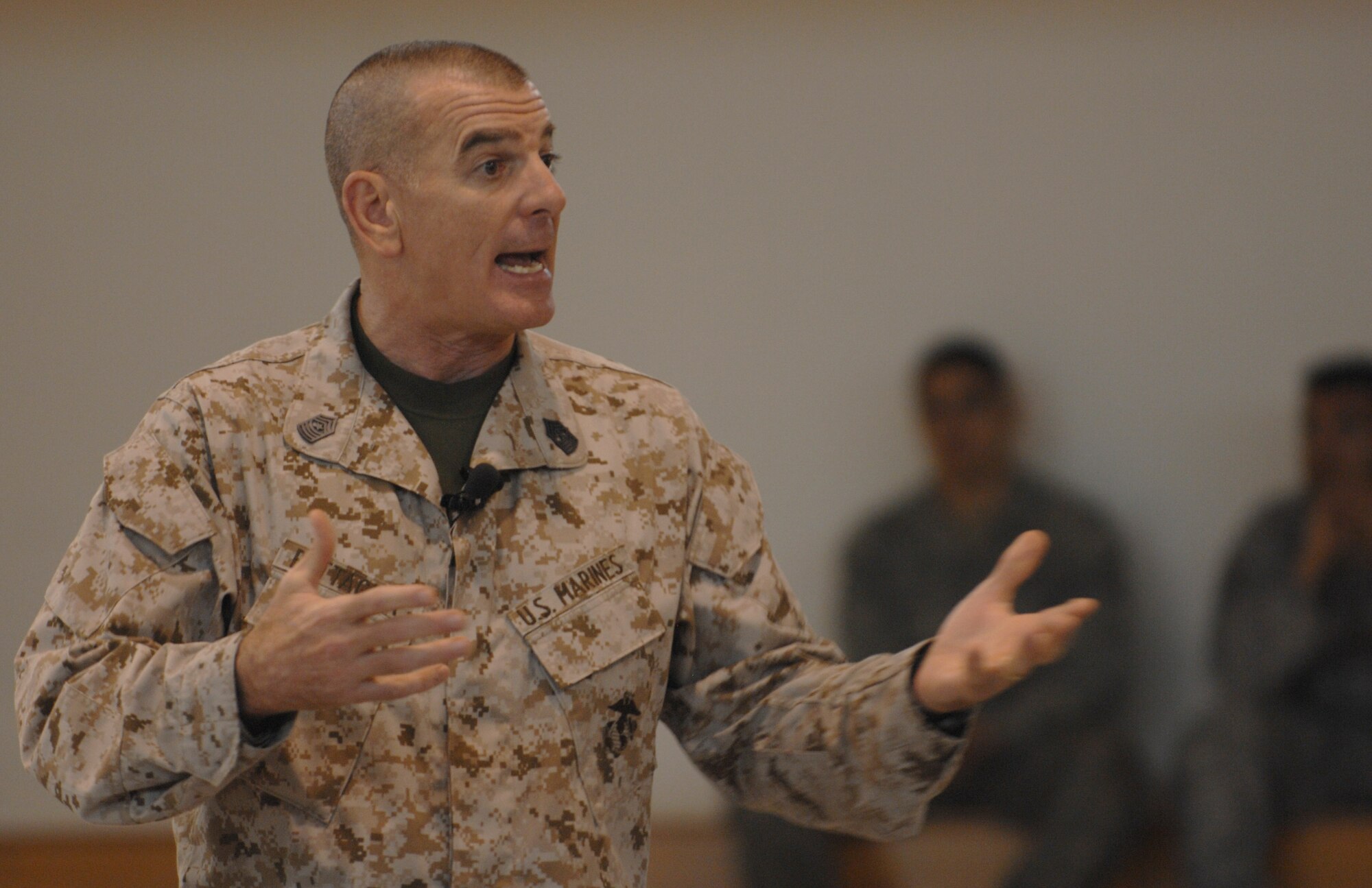 U.S. Marine Corps Sgt. Maj. Bryan Battaglia, senior enlisted advisor to the Chairman of the Joint Chiefs of Staff, speaks to Airmen June 20, 2013, during a base town hall meeting at the Hardstand Fitness Center on RAF Mildenhall, England. Battaglia spoke about military service, fitness and the priorities of the Chairman of the JCS.  (U.S. Air Force photo by Airman 1st Class Dillon Johnston/Released)