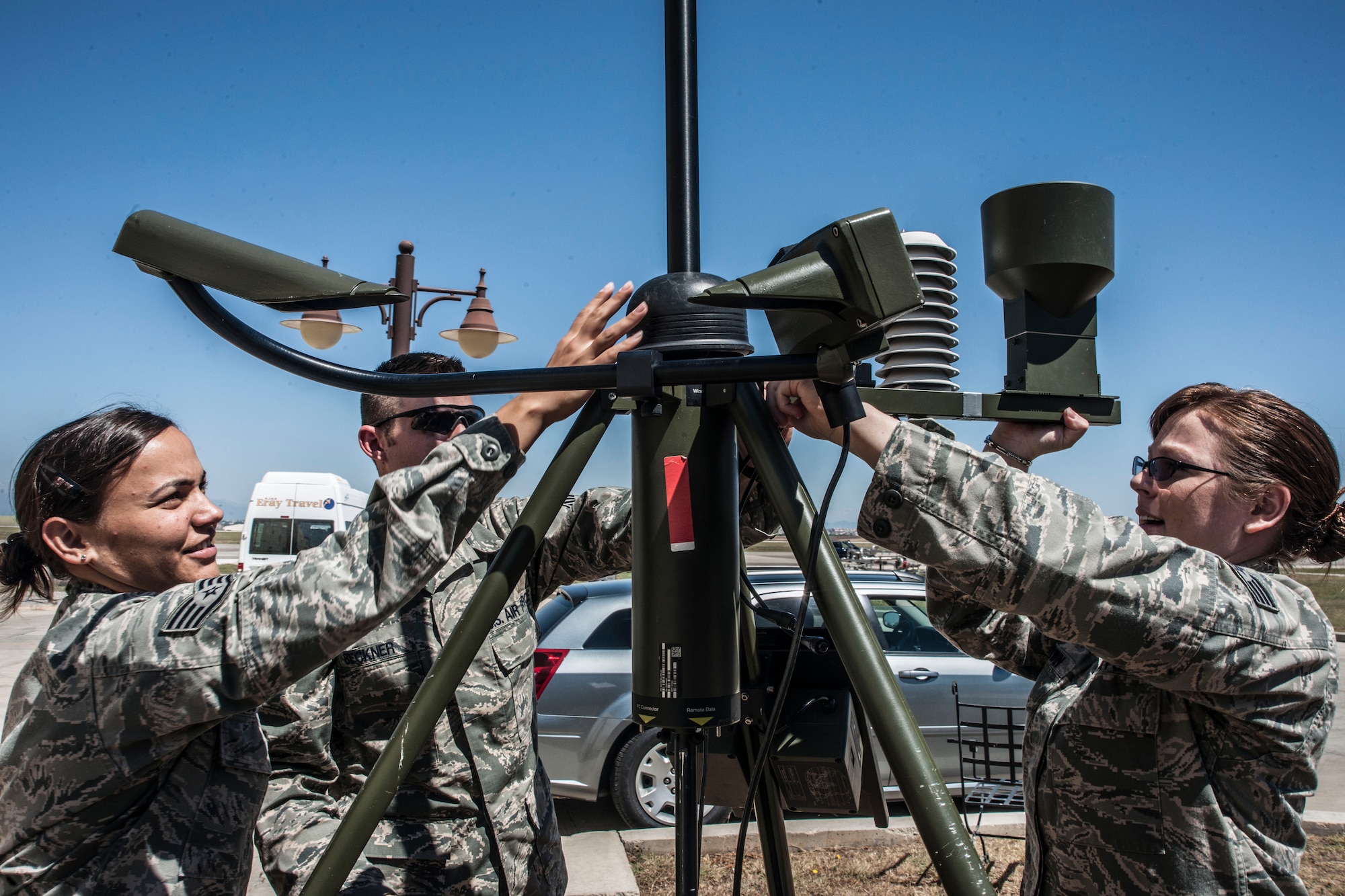 Staff Sgts. Elizabeth Goodwin, Natasha Smith and Michael Beckner, 39th Operations Squadron weather technicians, assemble a tactical meteorological equipment tower June 21, 2013, at Incirlik Air Base, Turkey. The tower tracks wind speed, temperature, cloud coverage, precipitation and lightning. (U.S. Air Force photo by Senior Airman Anthony Sanchelli/Released)
