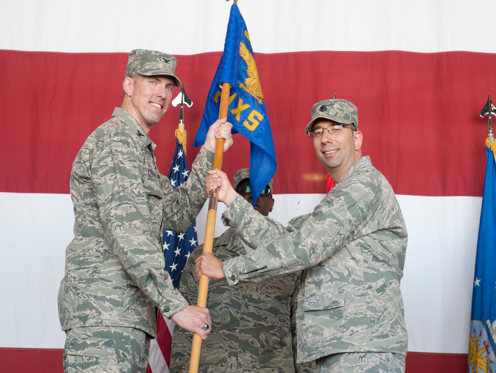 Col. Chris Craige, 39th Air Base Wing commander, passes the guidon to Lt. Col. David Holz, 39th Maintenance Squadron commander, during the 39th MXS change of command ceremony June 20, 2013, at Incirlik Air Base, Turkey. The ceremony signified the transition of command from Col. Mark Bowen to Holz. (U.S. Air Force photo by Senior Airman Daniel Phelps/Released)