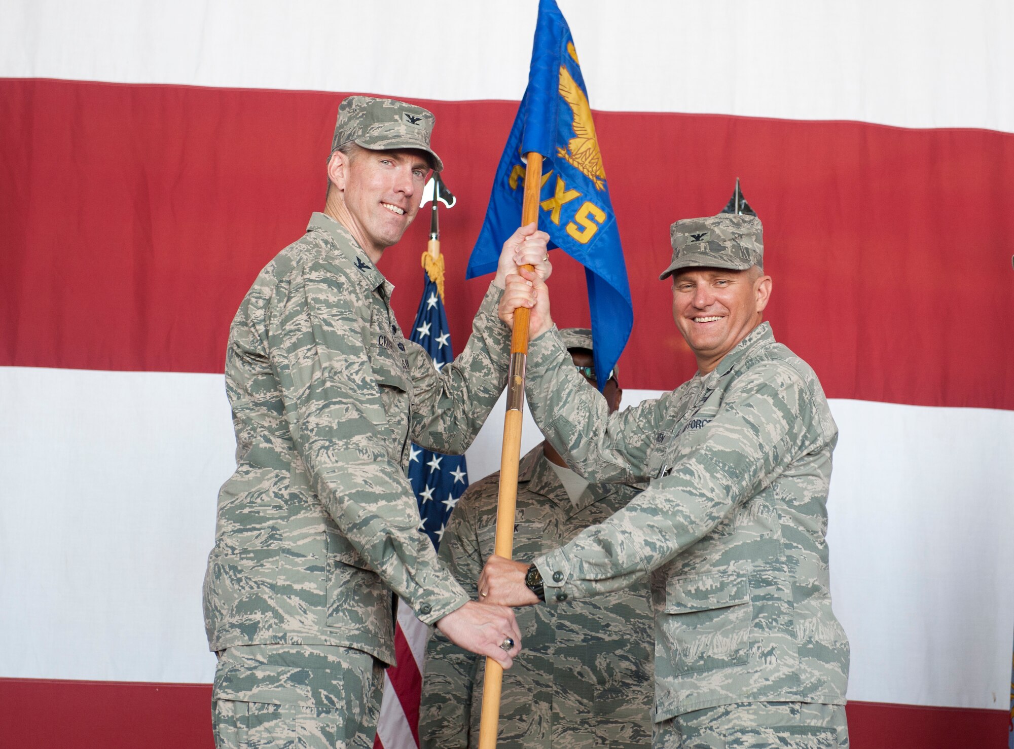 Col. Chris Craige, 39th Air Base Wing commander, receives the guidon from Col. Mark Bowen, outgoing 39th Maintenance Squadron commander, during the 39th MXS change of command ceremony June 20th, 2013, at Incirlik Air Base, Turkey. Command of the 39th MXS changed from Bowen to Lt. Col. David Holz. (U.S. Air Force photo by Senior Airman Daniel Phelps/Released)