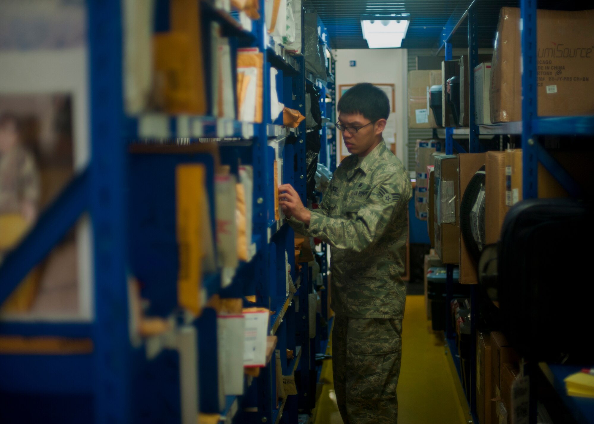 Senior Airman John Meneses, 51st Communications Squadron postal operations clerk, sorts packages at the Osan Post Office on Osan Air Base, Republic of Korea, June 19, 2013. The team delivers more than three million pounds of mail a year, and was recently named the best post office in the Air Force for 2012. (U.S. Air Force photo/Senior Airman Siuta B. Ika)