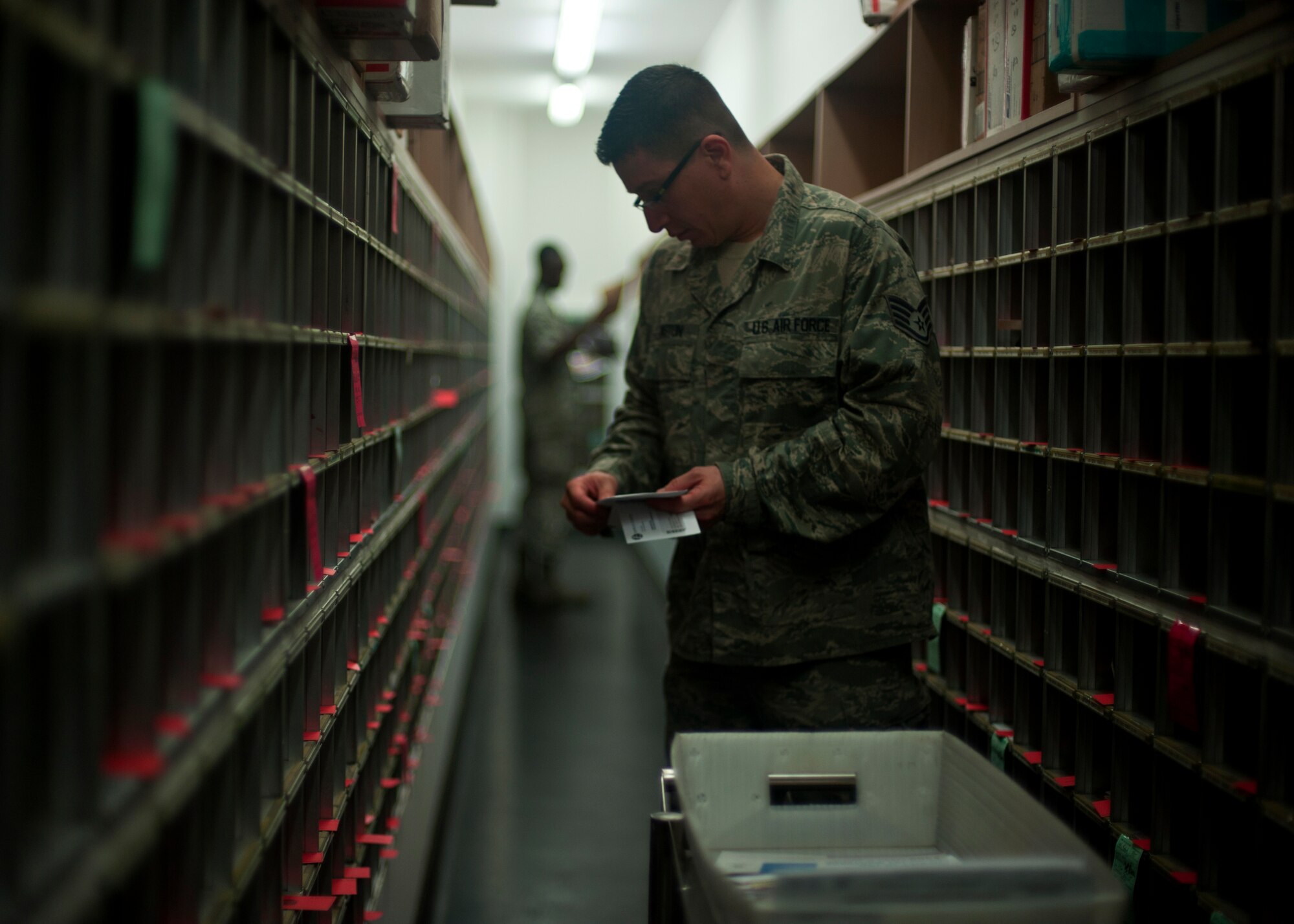 Staff Sgt. Clinton Pinkston, 51st Communications Squadron postal operations clerk, organizes mail into boxes at the Osan Post Office on Osan Air Base, Republic of Korea, June 19, 2013. The post office processes more than three million pounds of mail and services more than 11,000 personnel. (U.S. Air Force photo/Senior Airman Siuta B. Ika) 