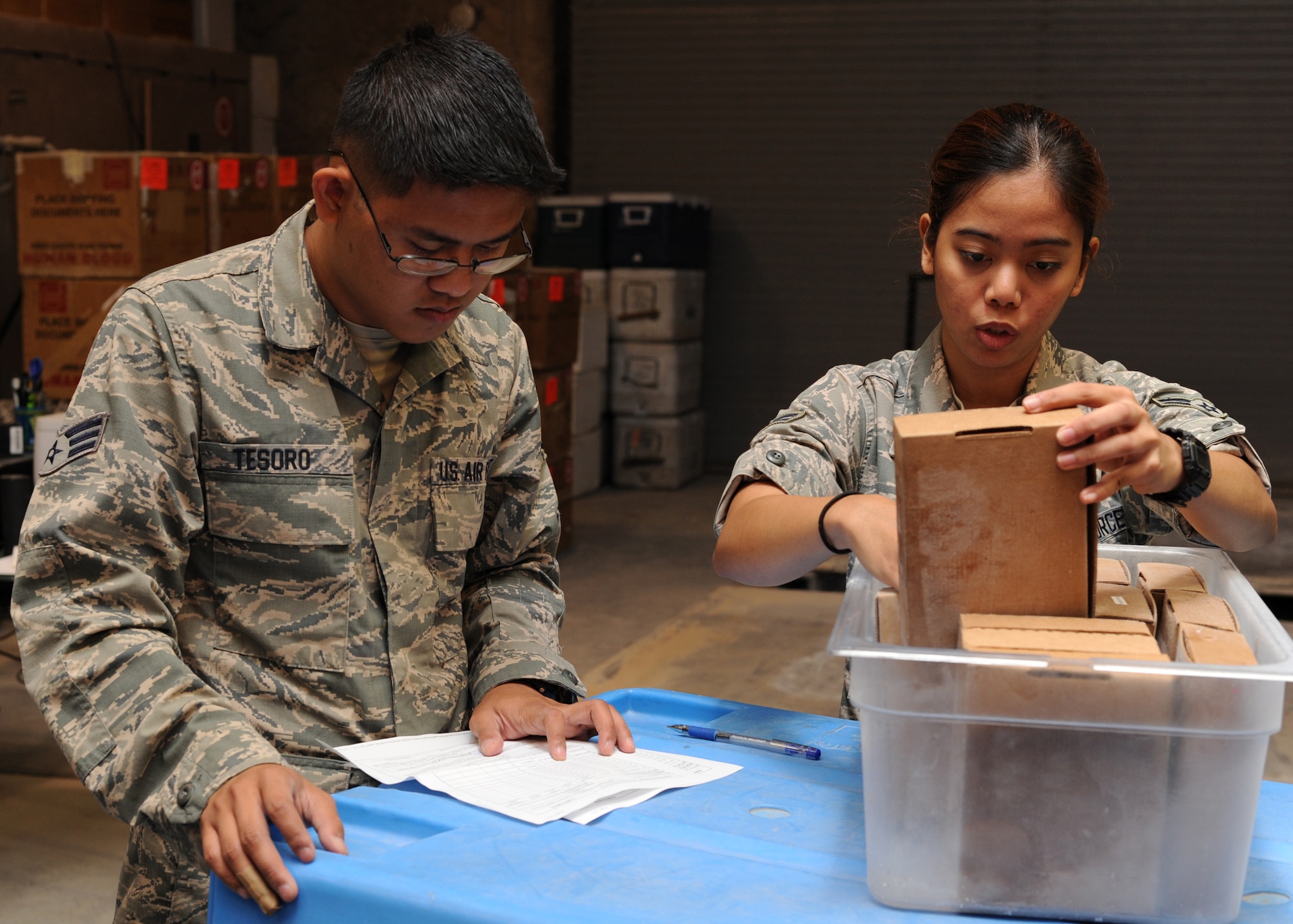 Senior Airman Leonard Tesoro and Airman 1st Class Patricia Ibanez verify the inventory of plasma boxes to be shipped at the379th Air Expeditionary Wing’s Blood Transshipment Center in Southwest Asia, June 13, 2013. The plasma boxes were then packed into dry ice and shipped to Afghanistan with other blood products. Tesoro is a 379th Expeditionary Medical Support Squadron BTC lab technician deployed from Eglin Air Force Base, Fla., and Ibanez is a 379th EMDSS BTC administrative technician deployed from Shaw Air Force Base, S.C.  (U.S. Air Force photo/Senior Airman Bahja J. Jones)