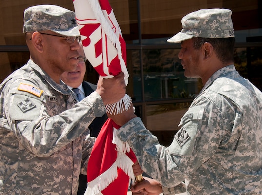 Lt. Gen. Tom Bostick, Chief of the U.S. Army Corps of Engineers, passes the South Pacific Division's Colors to Col. C. David Turner during a Change of Command ceremony Wednesday, June 19, 2013 at the Bay Model in Sausalito, Calif. Col. Turner became the 55th Commander of the South Pacific Division after assuming command from Col. Andrew Nelson, who is resuming duties as the Division Deputy Commander.