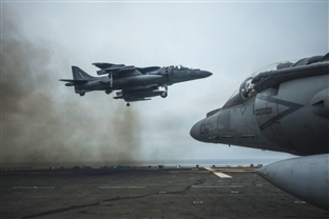An AV-8B harrier jet performs a vertical landing on the flight deck of the USS Boxer in the Pacific Ocean, June 14, 2013. The Boxer is conducting amphibious squadron and marine expeditionary unit integrated training. The jet is part of the air combat element of the 13th Marine Expeditionary Unit.