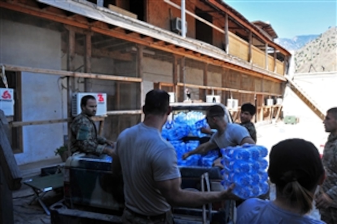 U.S. and Afghan soldiers supply a compound after retrieving a sling-load drop on former Forward Operating Base Bostik in Kunar province, Afghanistan, June 5, 2013. The soldiers are assigned to the 101st Airborne Division's Company C, 2nd Battalion, 327th Infantry Regiment, 1st Brigade Combat Team.