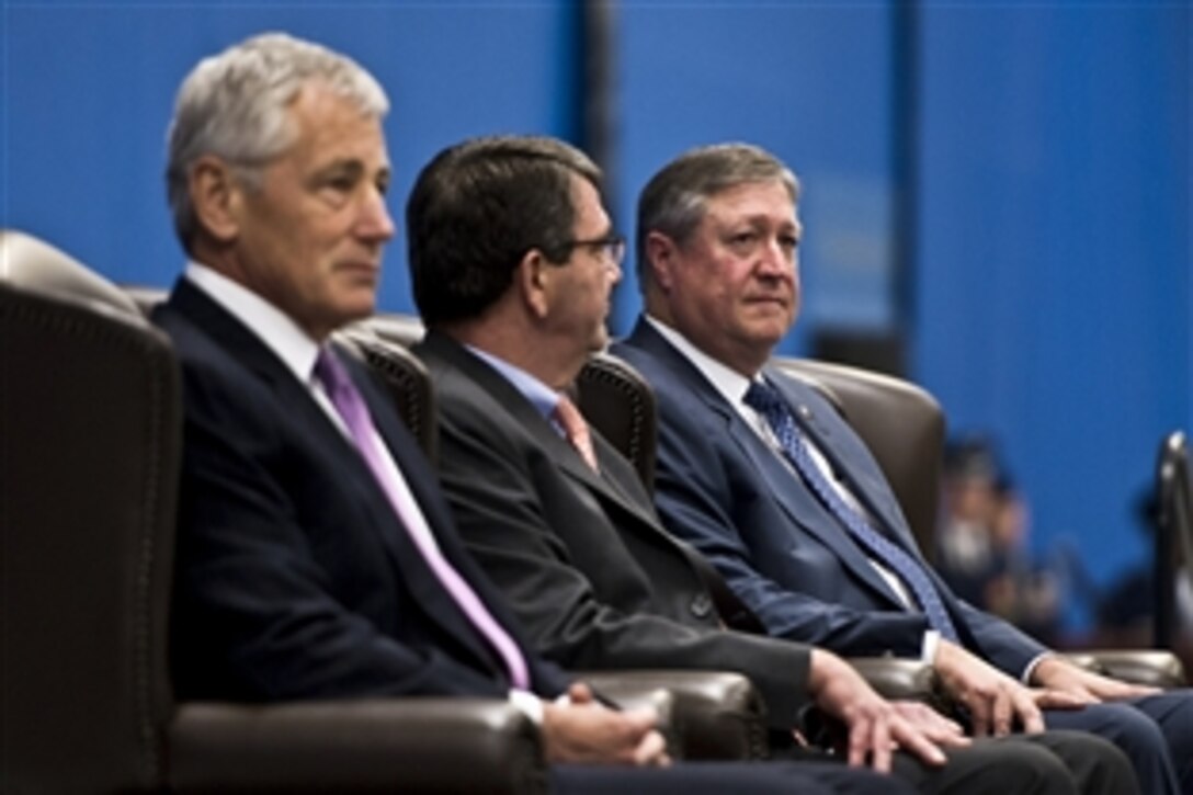 Defense Secretary Chuck Hagel, left, and Deputy Defense Secretary Ash Carter, center, sit with Air Force Secretary Michael B. Donley during his farewell ceremony on Joint Base Andrews, Md., June 21, 2013. Donley served as the 22nd and longest serving Air Force secretary. 
