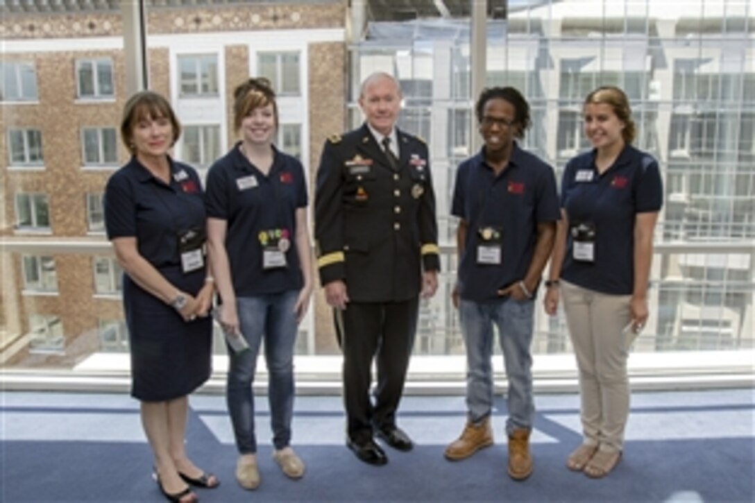 Army Gen. Martin E. Dempsey poses for a photo with young “back pack” journalists who interviewed him at  the 2013 Service Unites Conference on Volunteering and Service sponsored by Points of Light in Washington, D.C., June 21, 2013.  